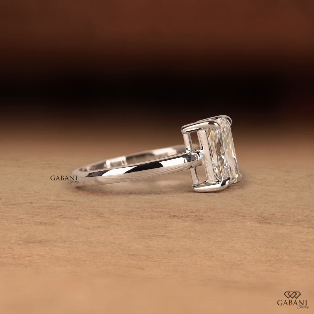 Radiant cut lab grown diamond solitaire engagement ring in 18K white gold with a classic four claw prong setting and polished band.