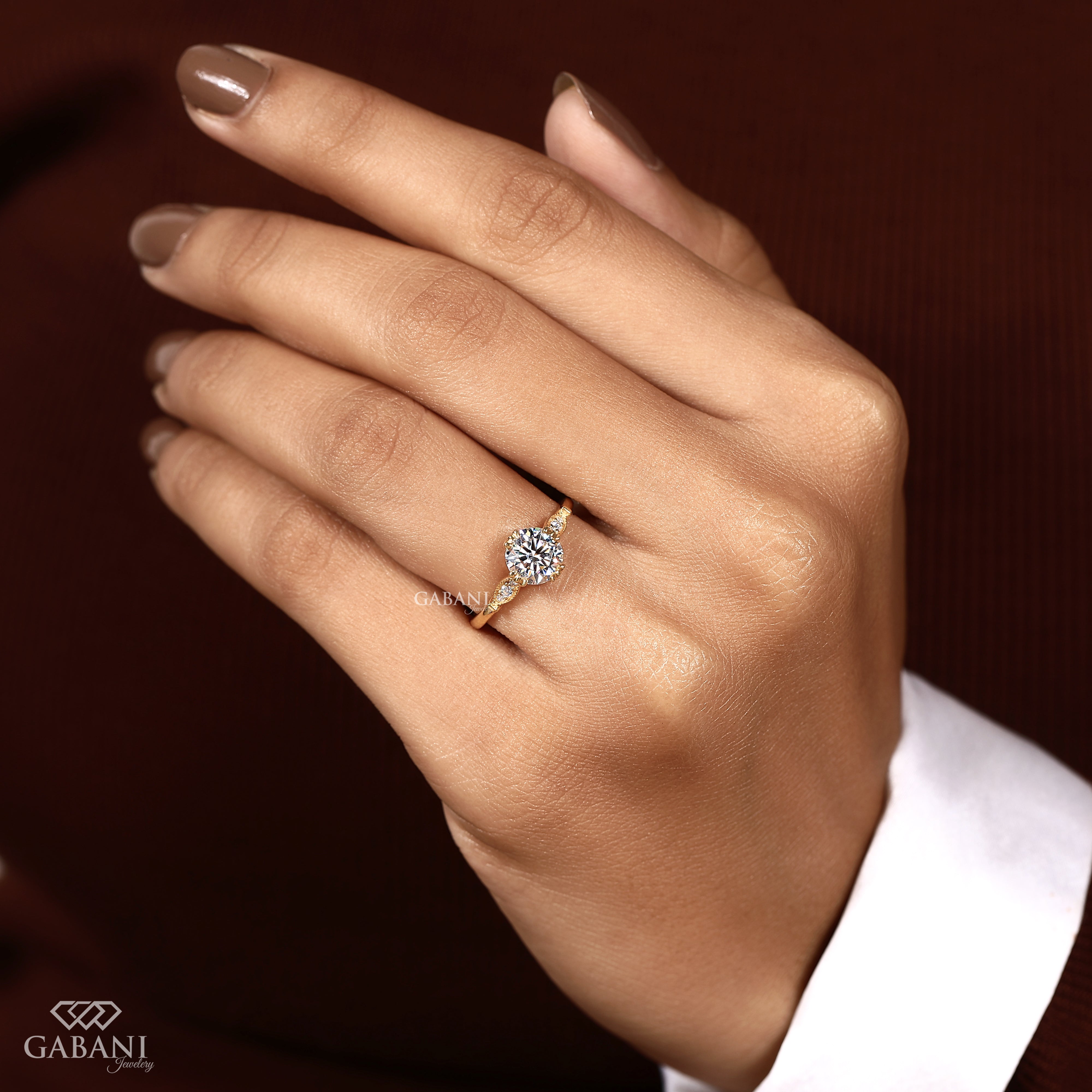 Round brilliant lab created diamond engagement ring worn on model hand