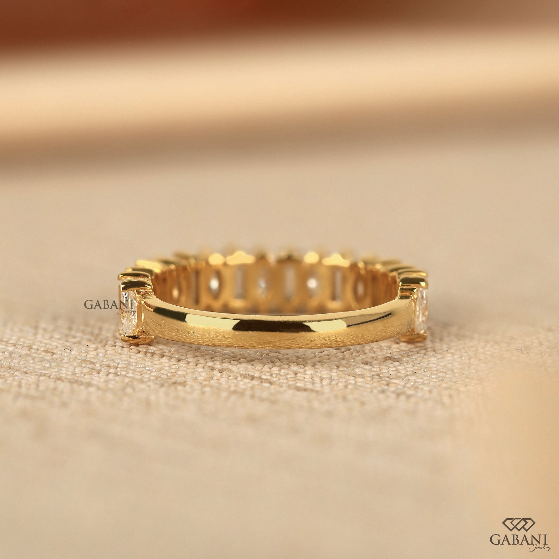 Gold half eternity band with baguette and marquise lab grown diamonds