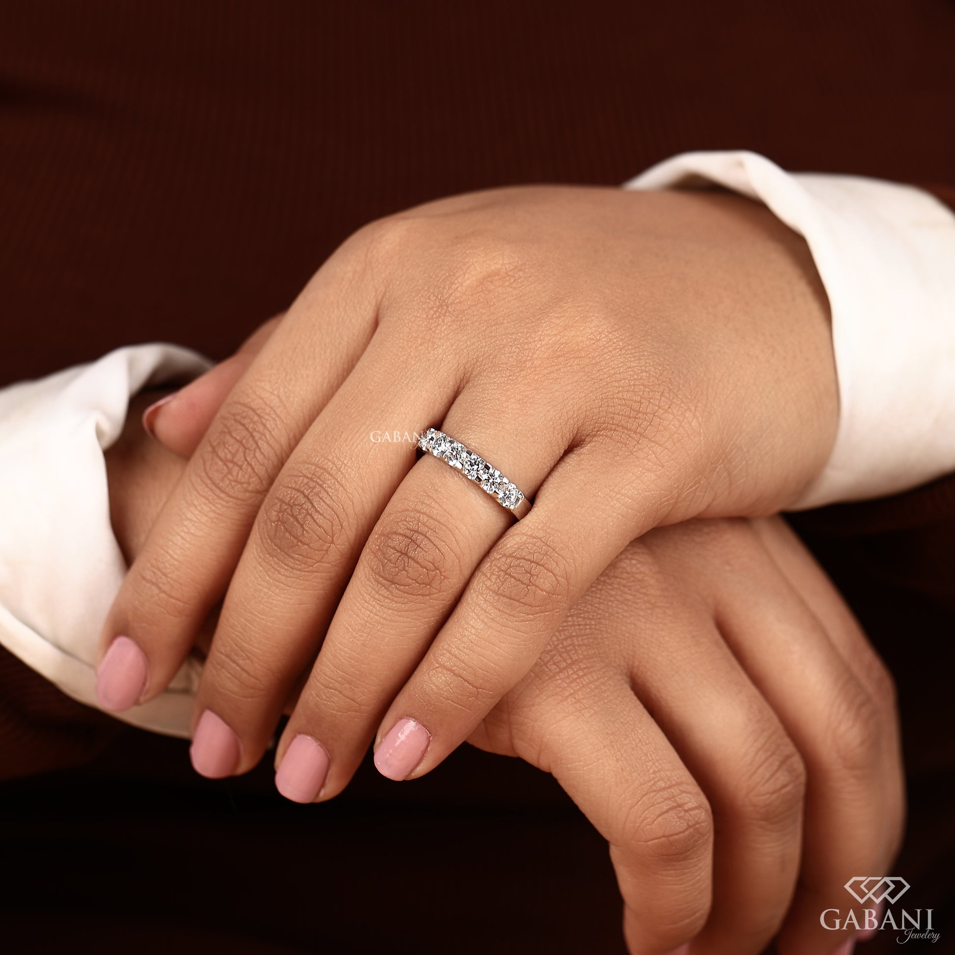 round lab grown diamond seven stone band in polished white gold French pavé design