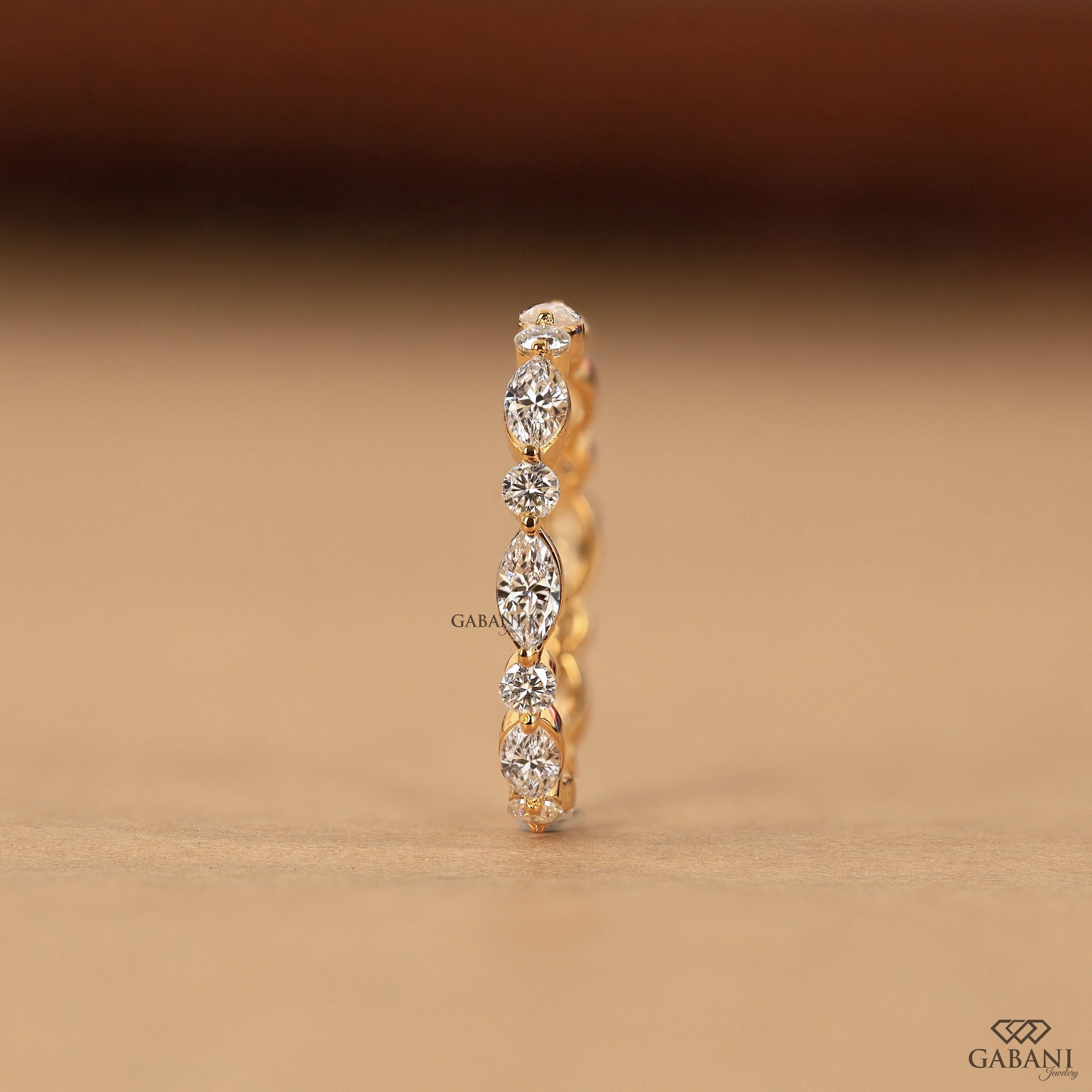 marquise and round diamond stacking band in gold eternity style