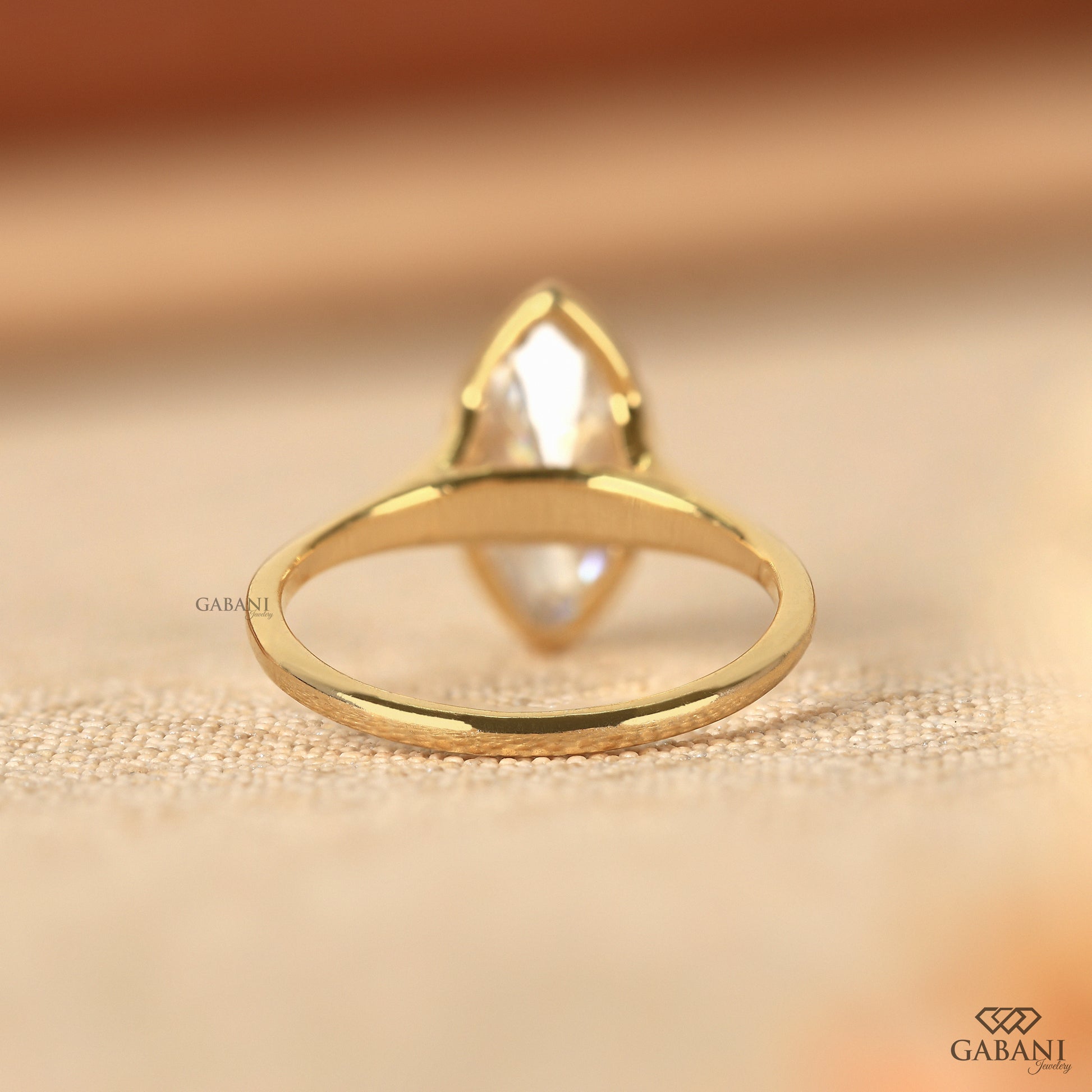 Marquise cut lab diamond solitaire ring featuring a split shank bezel setting