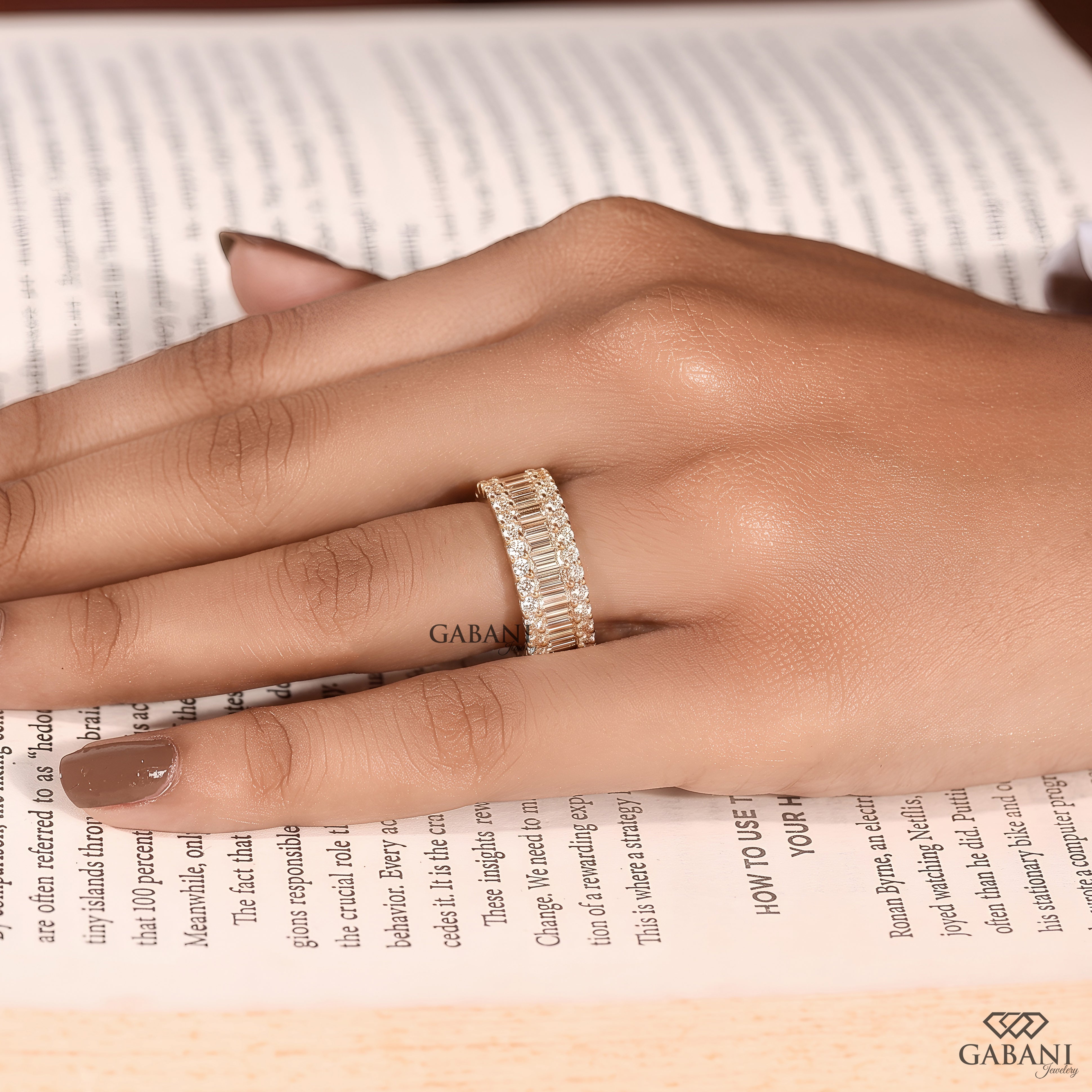 Front display of a wide yellow gold wedding band featuring standing baguette and round lab grown diamonds