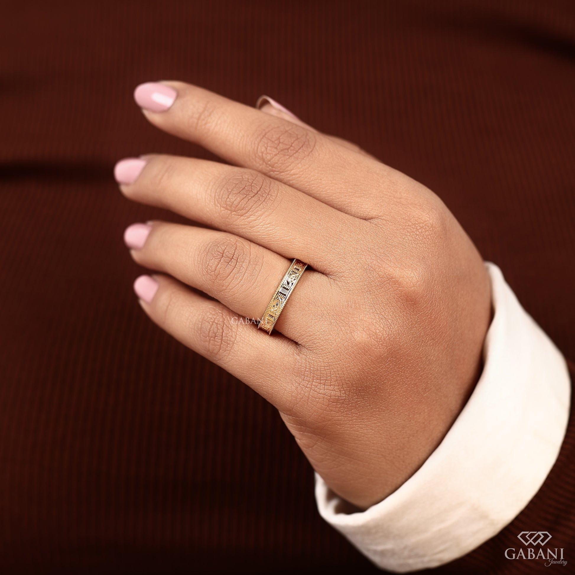 Macro detail of milgrain edge and leaf motif on yellow gold ring, highlighting texture, engraving, and subtle diamond sparkle
