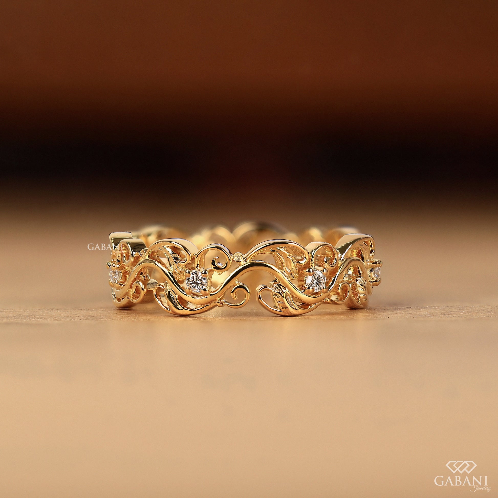 nature inspired wide diamond band with leaf pattern in yellow gold