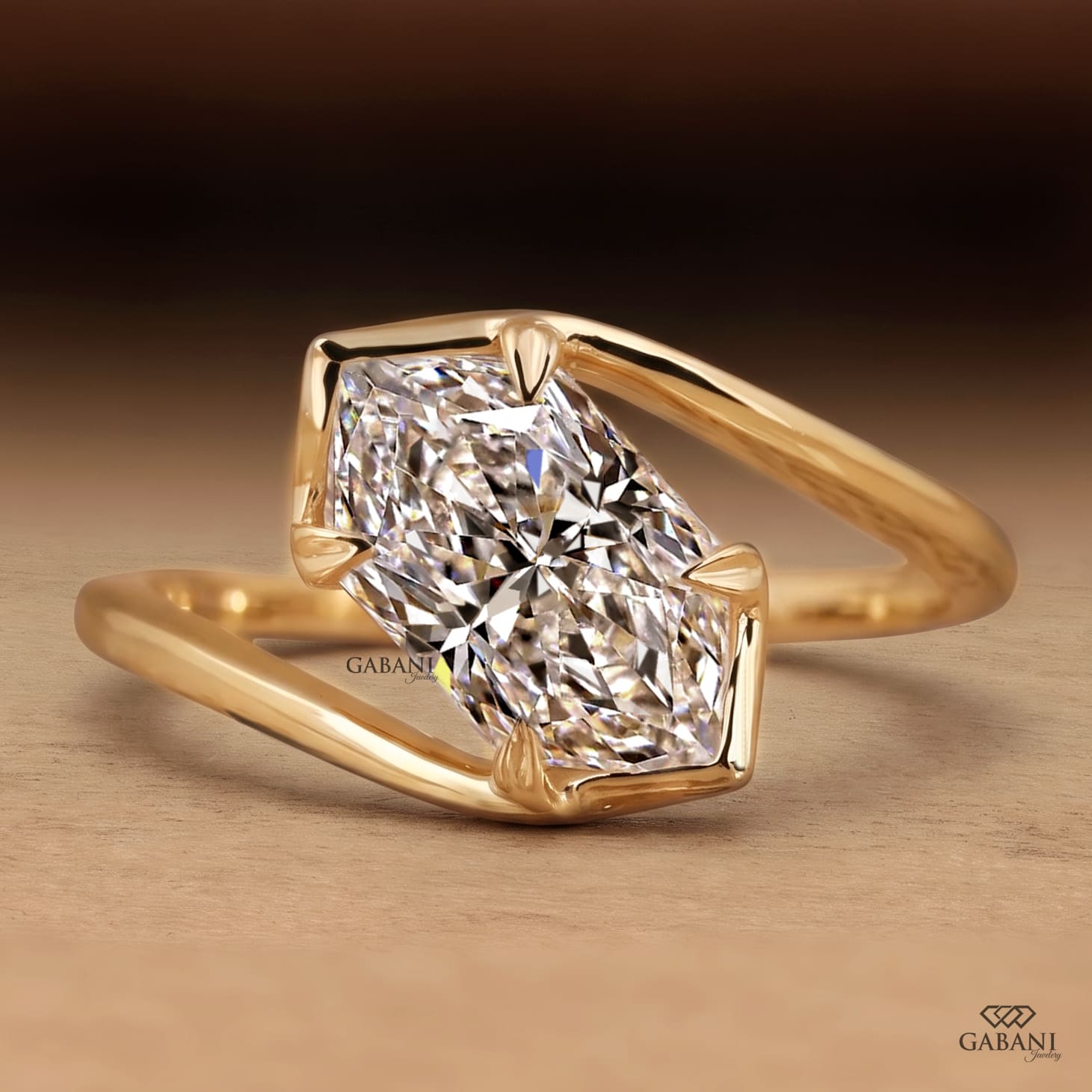 Marquise cut lab grown diamond engagement ring with prong setting, modern split shank design and polished yellow gold band.