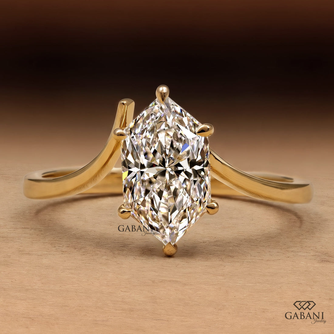 Marquise cut lab grown diamond solitaire engagement ring with six prong setting, curved shank and polished yellow gold band.