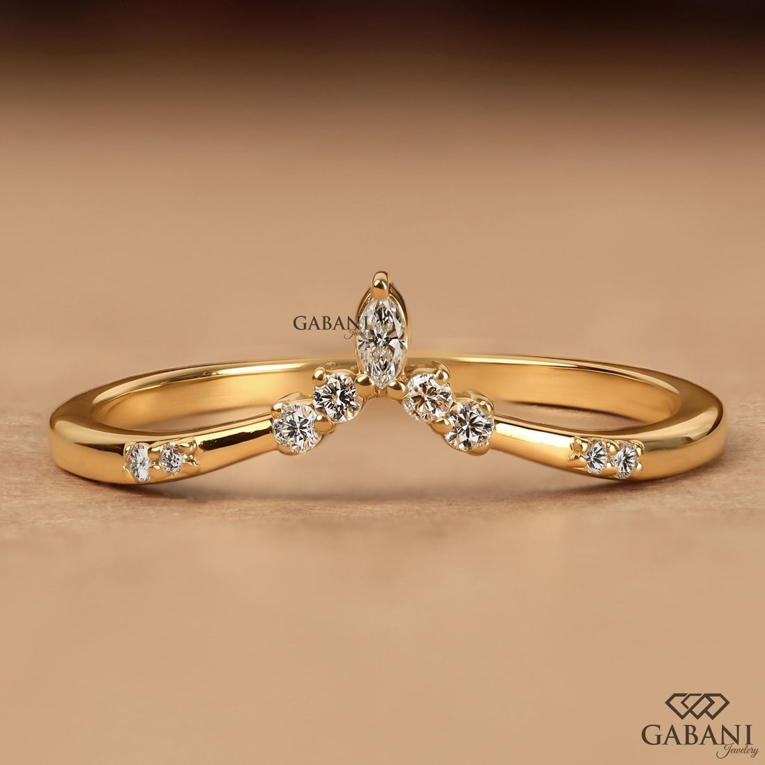 Marquise and round cut lab grown diamond curved wedding band in yellow gold with V shaped contour design for stacking with an engagement ring.