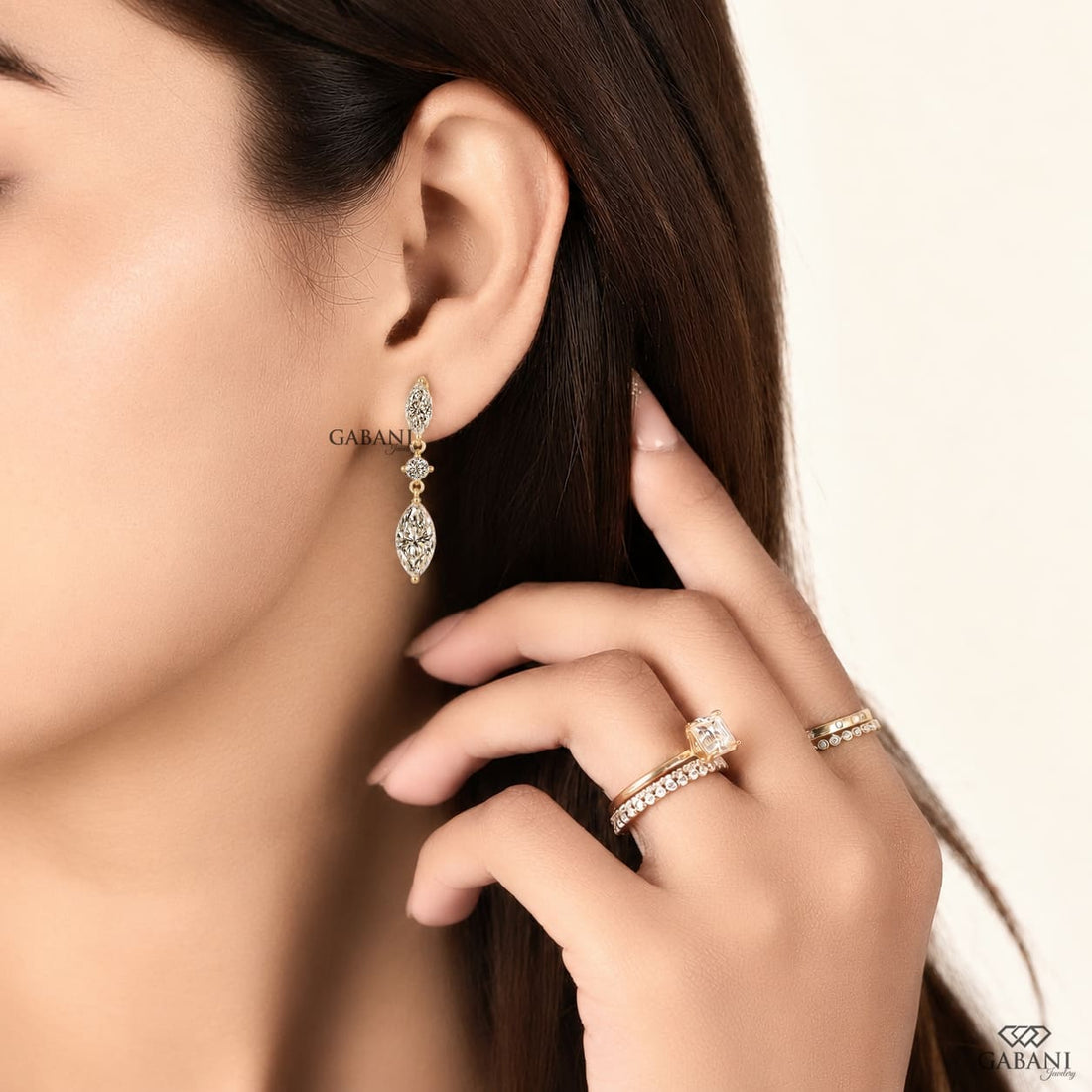 marquise and round cut lab grown diamond drop earrings in yellow gold, featuring two sparkling marquise diamonds connected by a round brilliant diamond on each earring, creating an elegant three-stone design by Gabani Jewelry.