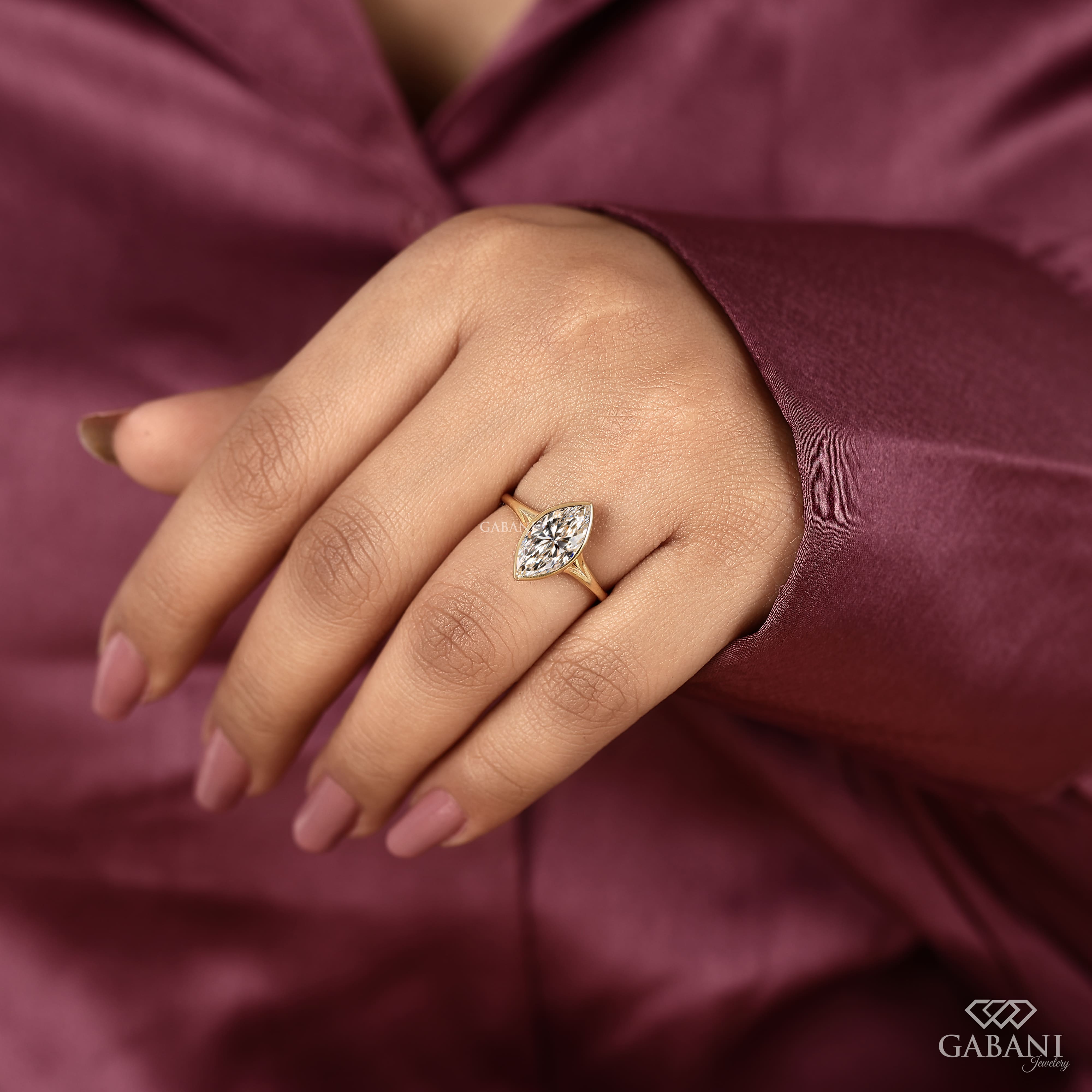 marquise cut diamond solitaire engagement ring with full bezel setting in yellow gold