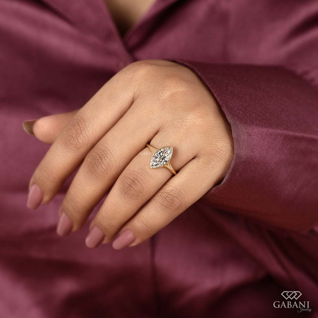 marquise cut diamond solitaire engagement ring with full bezel setting in yellow gold