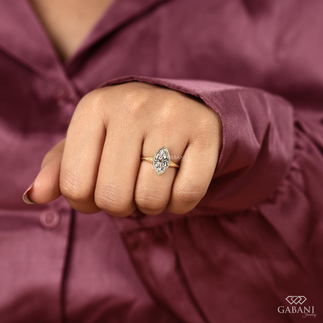 marquise cut diamond solitaire engagement ring with full bezel setting in yellow gold