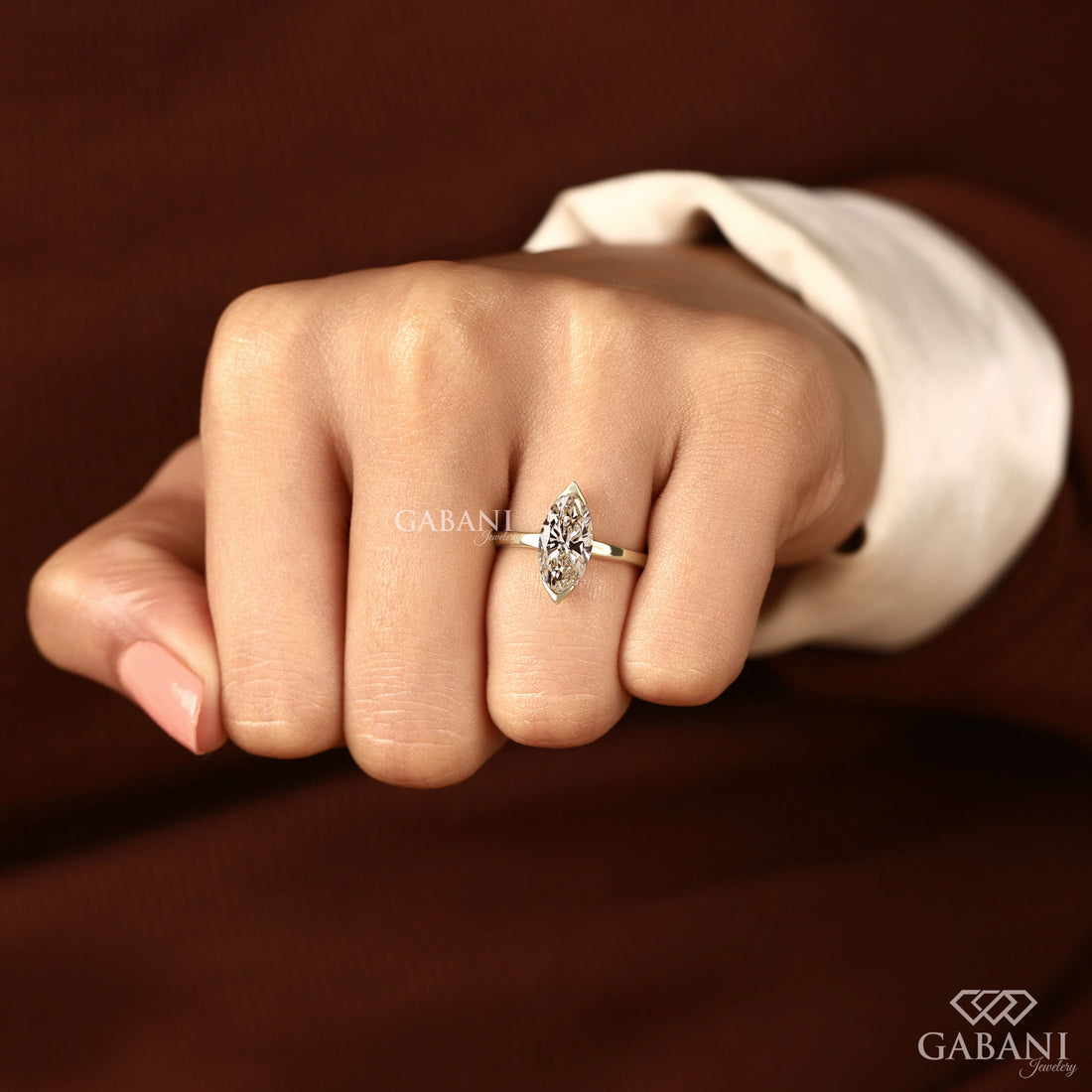 marquise cut lab grown diamond solitaire engagement ring with half bezel setting and polished 14K yellow gold band