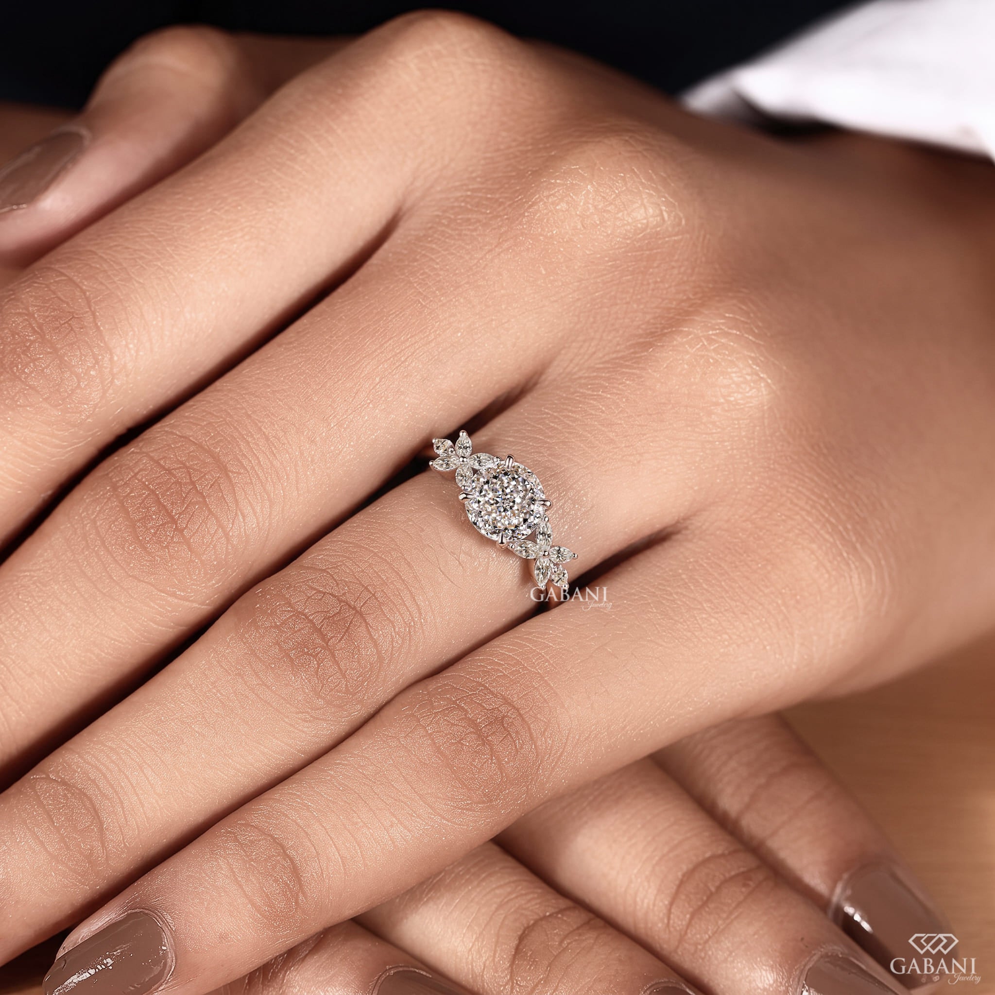 Round Portuguese cut lab grown diamond engagement ring with marquise leaf side stones in polished white gold.