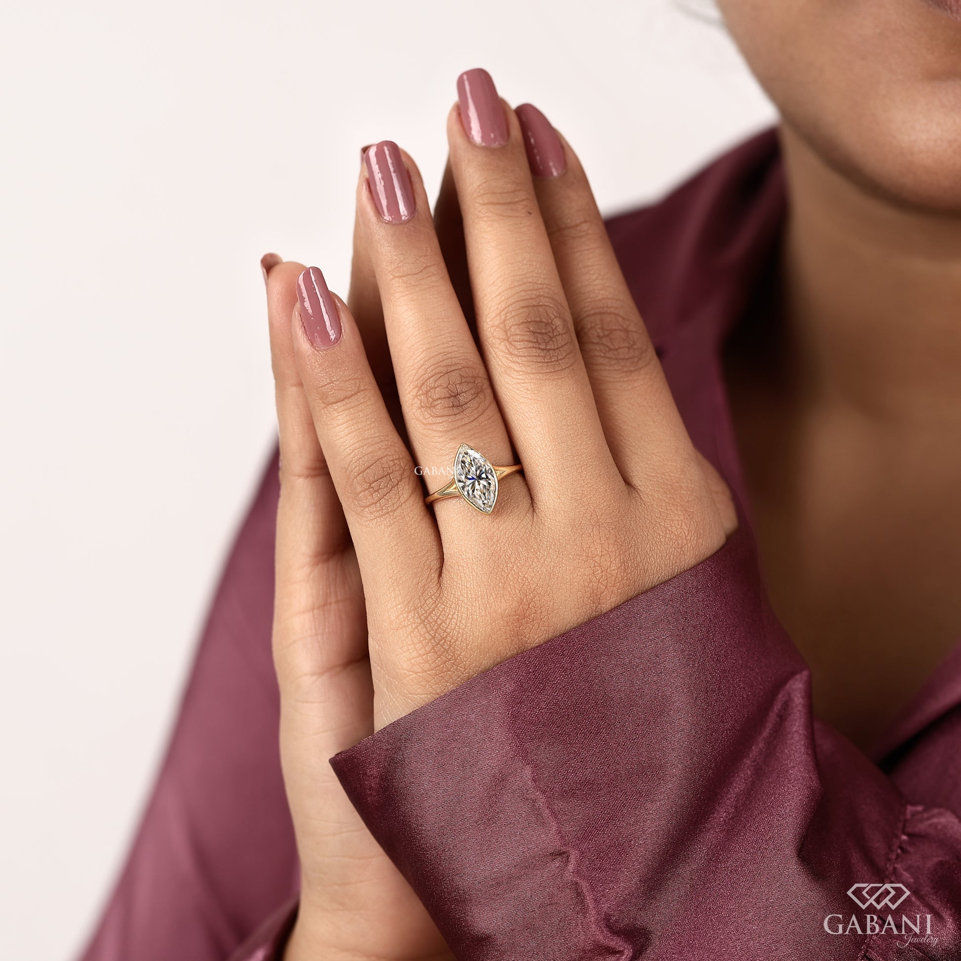 Yellow gold marquise lab grown diamond ring with secure bezel and low profile design