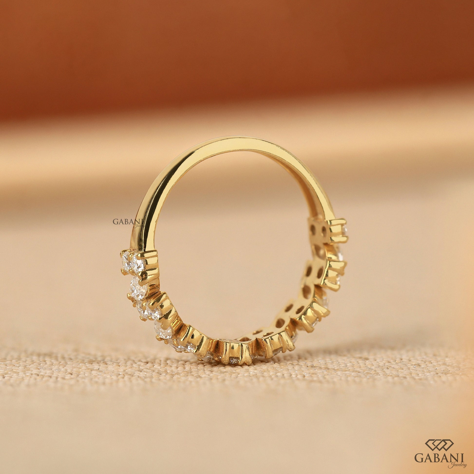 modern yellow gold band with prong set marquise and round lab grown diamonds