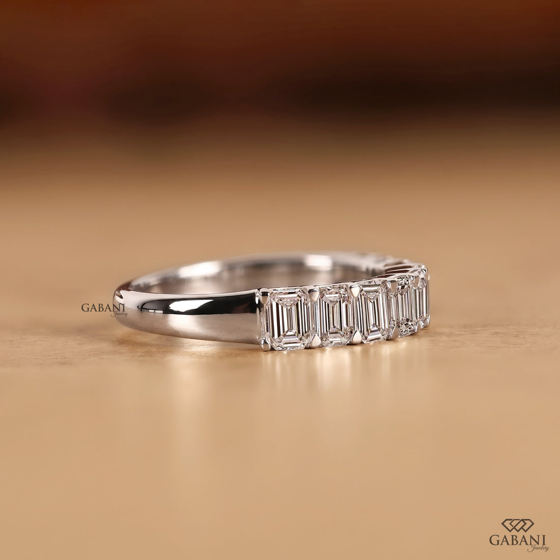 Side view of an emerald cut diamond wedding band featuring lab created diamonds in smooth white gold