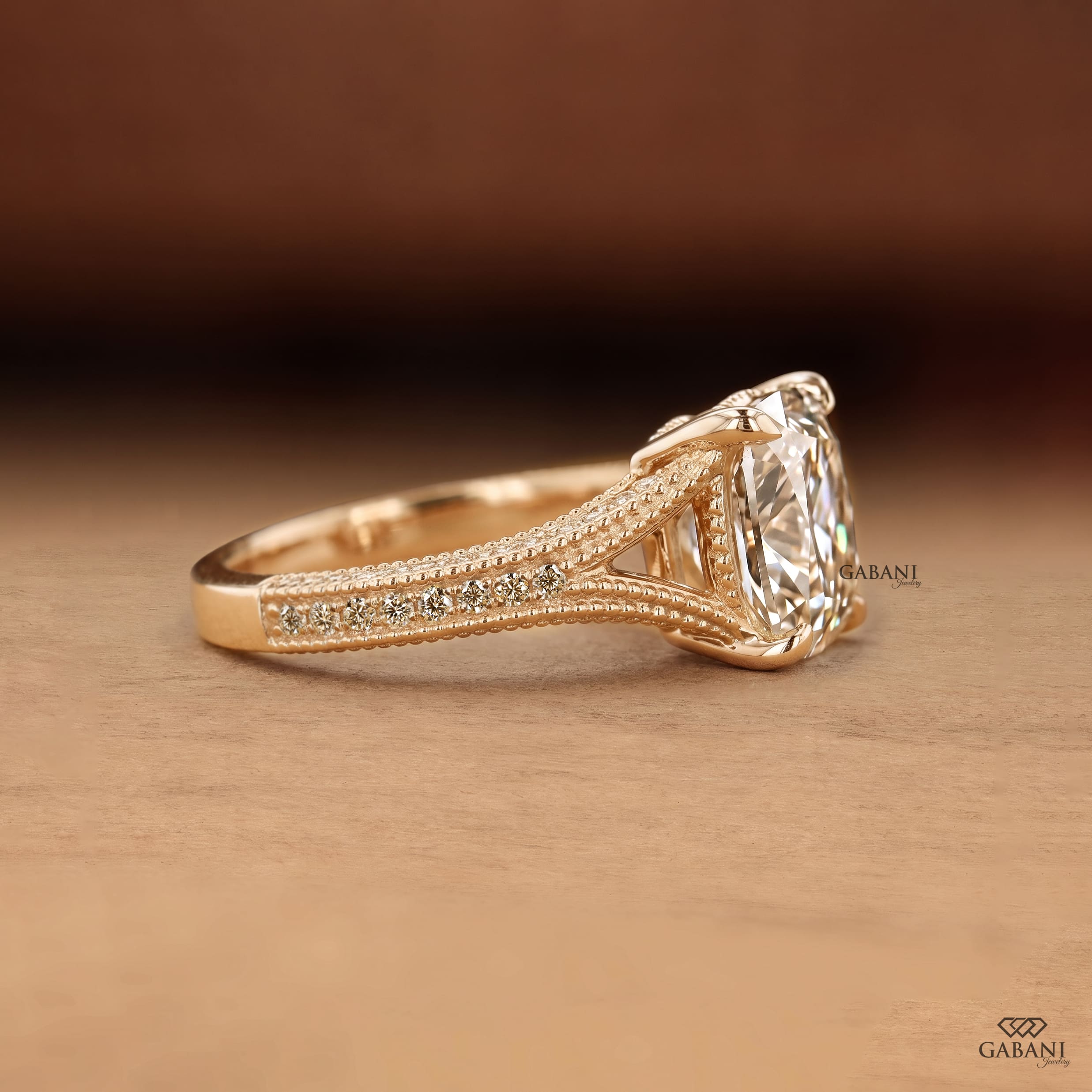 old mine cushion cut lab grown diamond engagement ring with split shank, round diamond accents and milgrain detail in 14K yellow gold.
