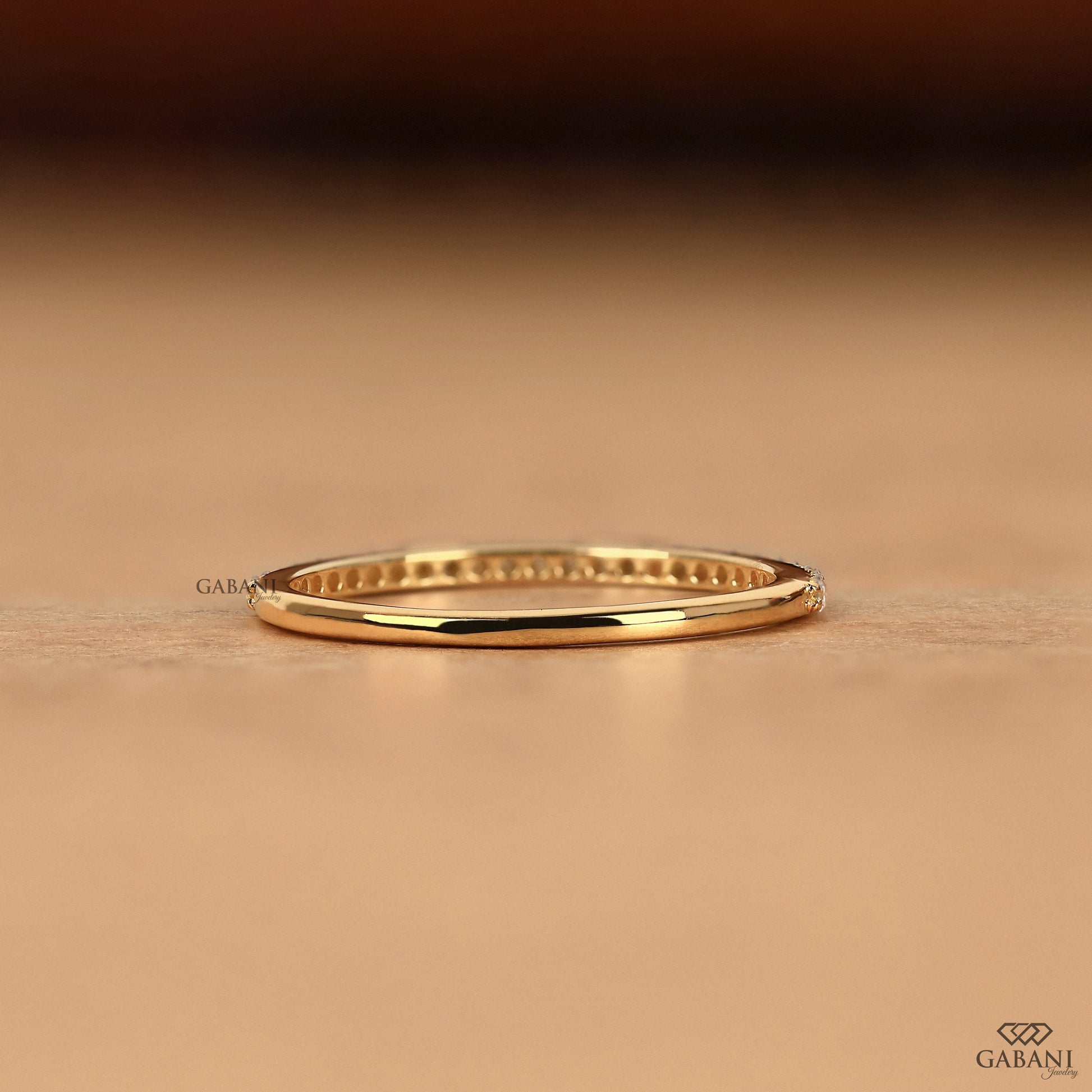 thin 14k gold diamond band with round lab diamonds in half eternity pave design