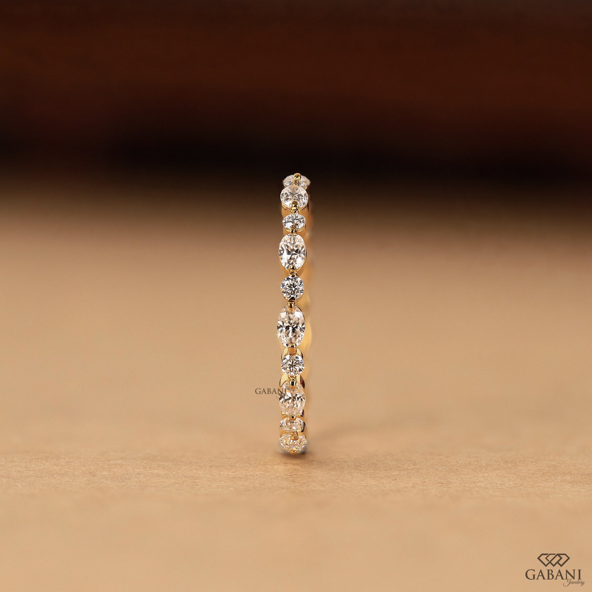 dainty eternity band with oval and round lab diamonds in gold