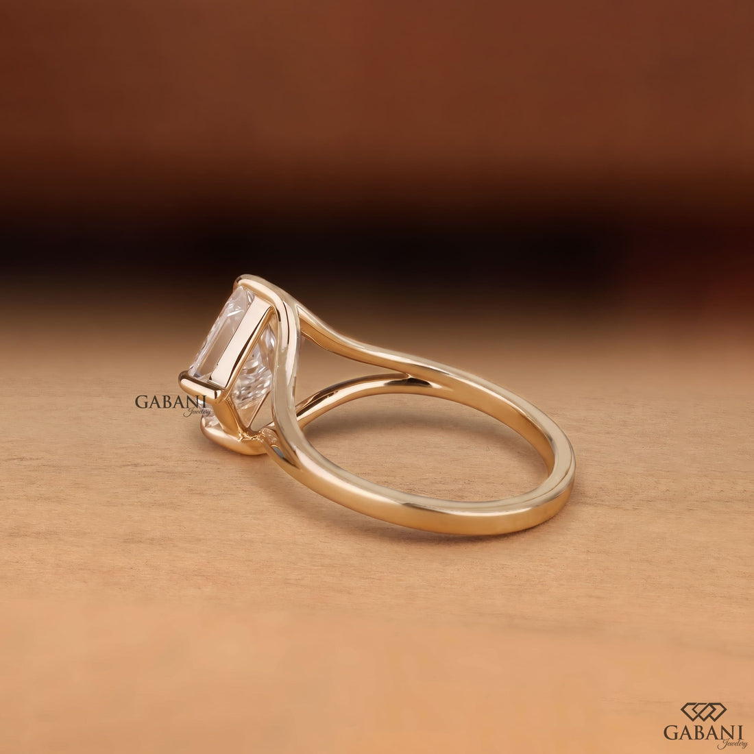 Princess cut lab grown diamond engagement ring in yellow gold featuring a kite set center stone, four prong setting, and modern open split shank design.