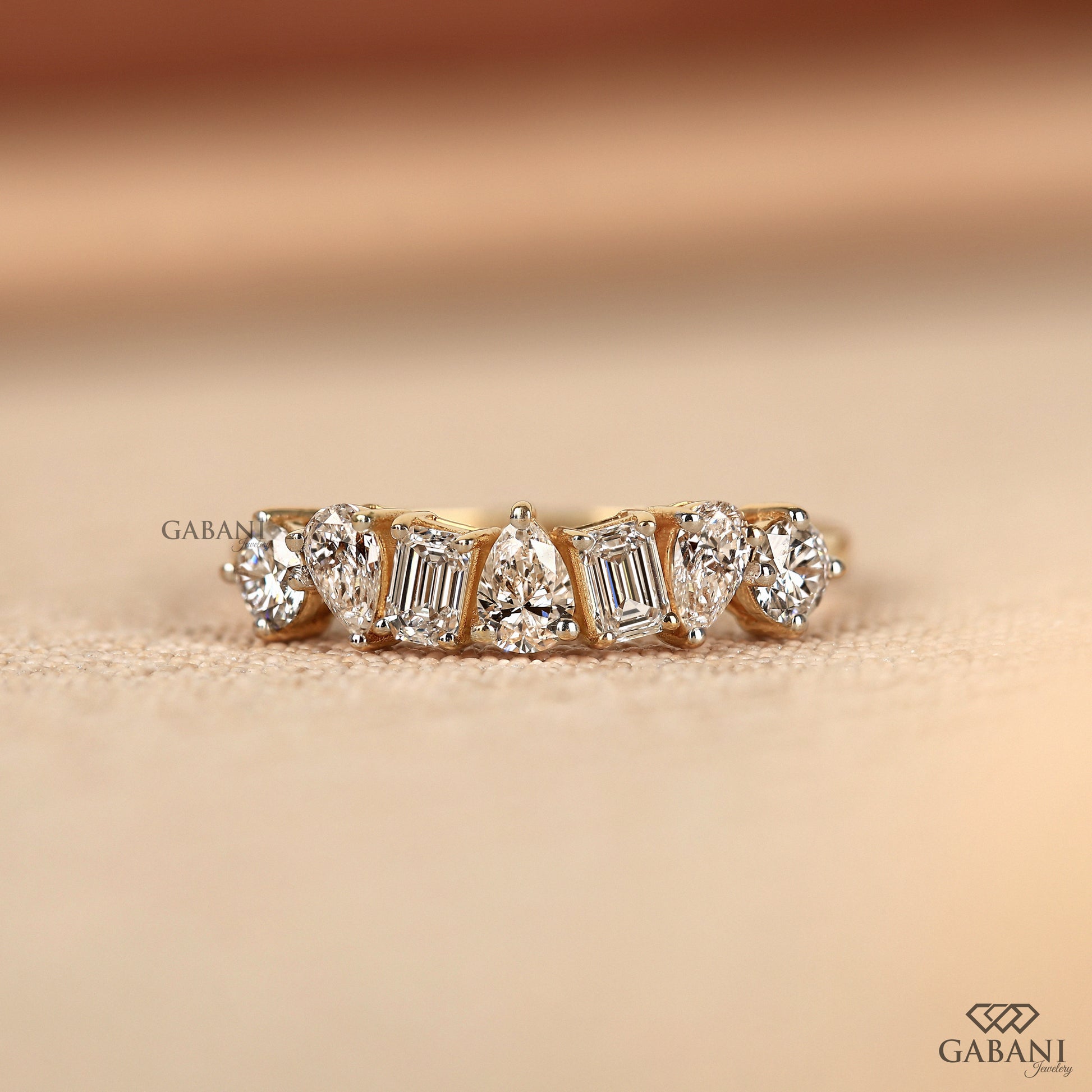 Lab grown diamond wedding band with emerald pear and round cuts in yellow gold