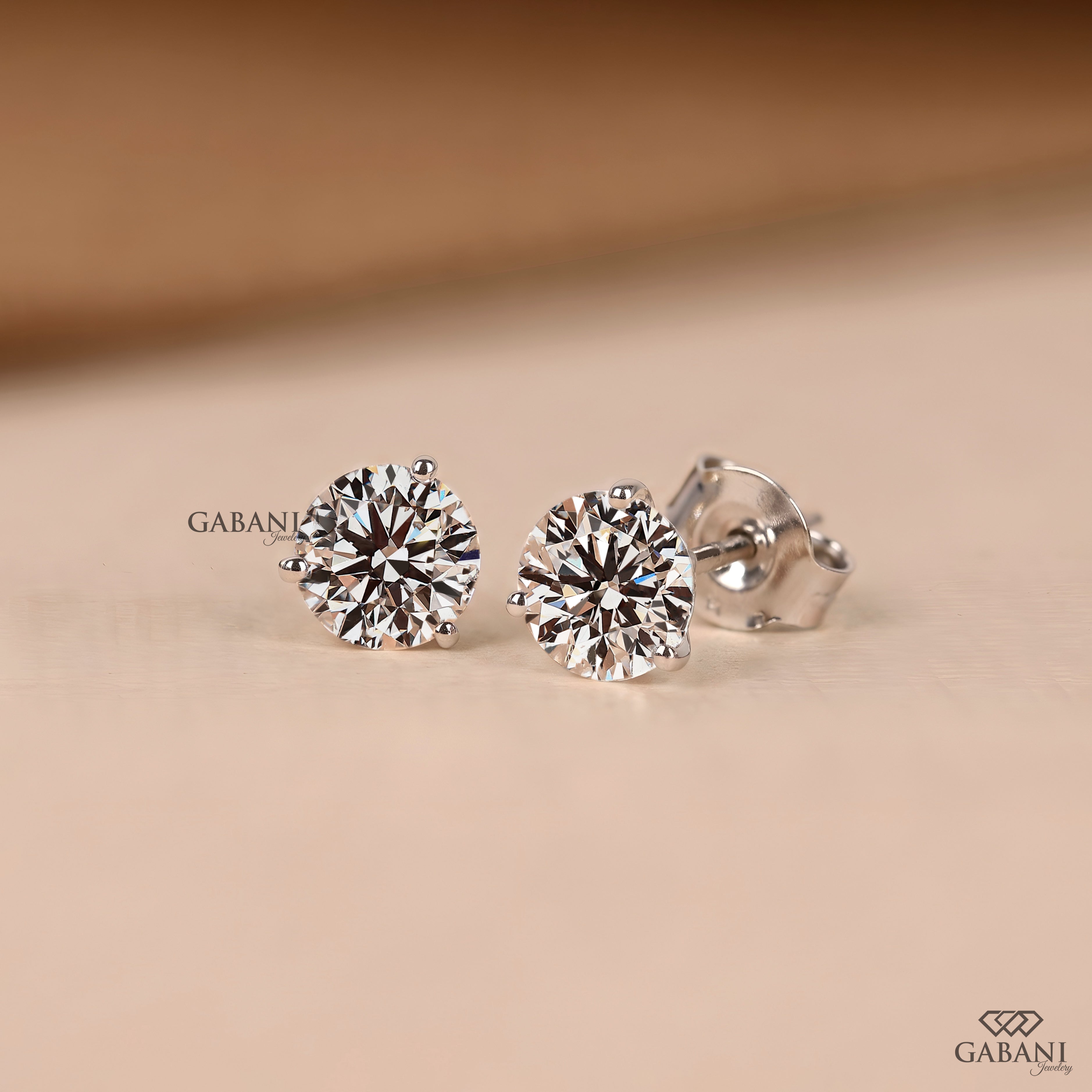 Round cut diamond stud earrings designed with a delicate prong setting