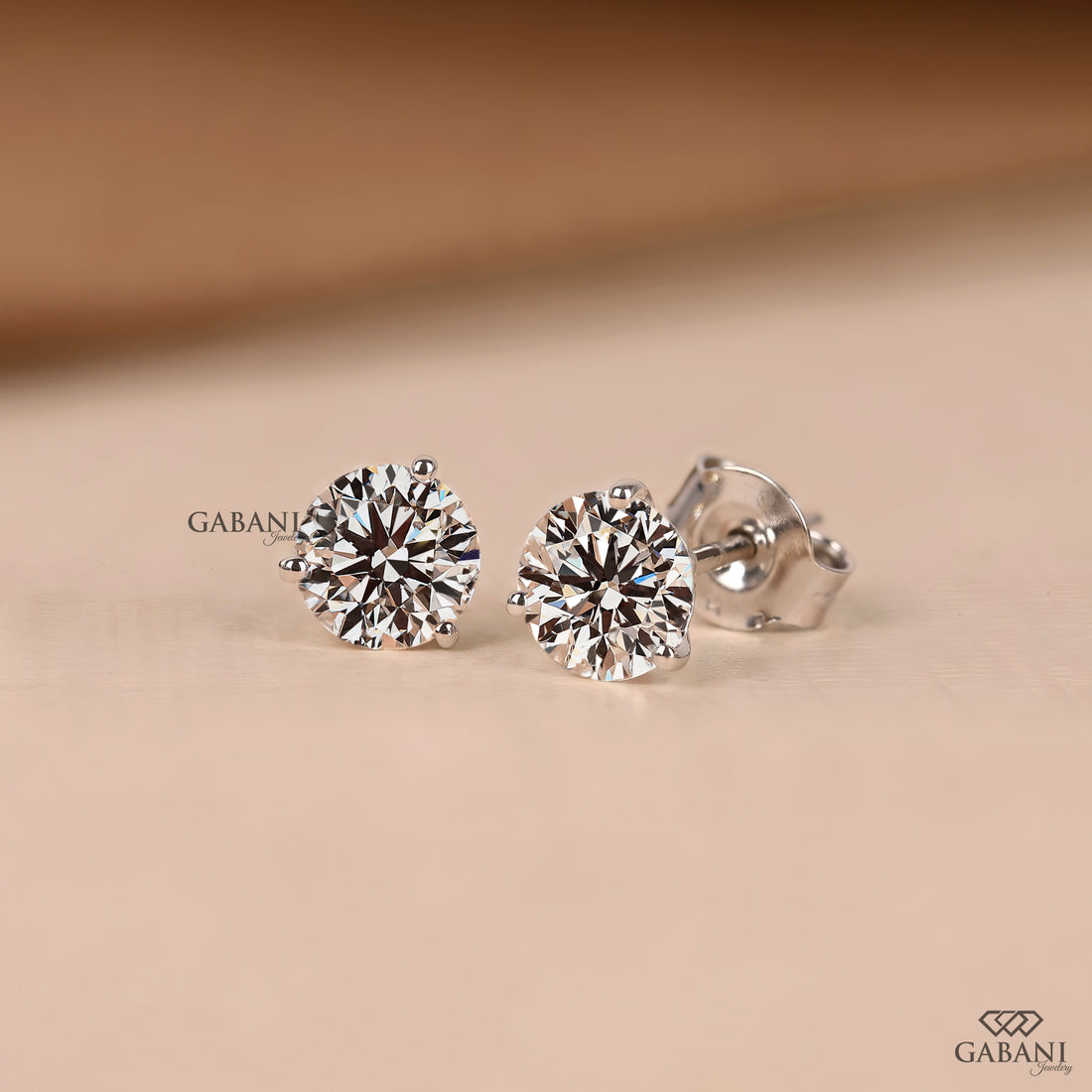 Round cut diamond stud earrings designed with a delicate prong setting