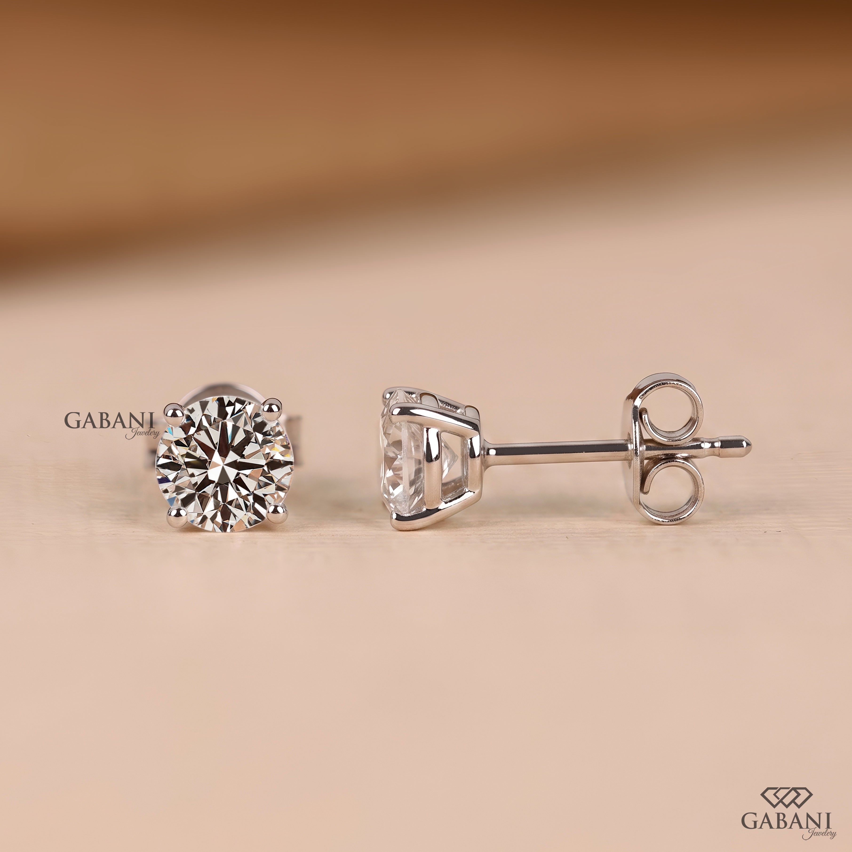 Round cut diamond stud earrings designed with a delicate prong setting