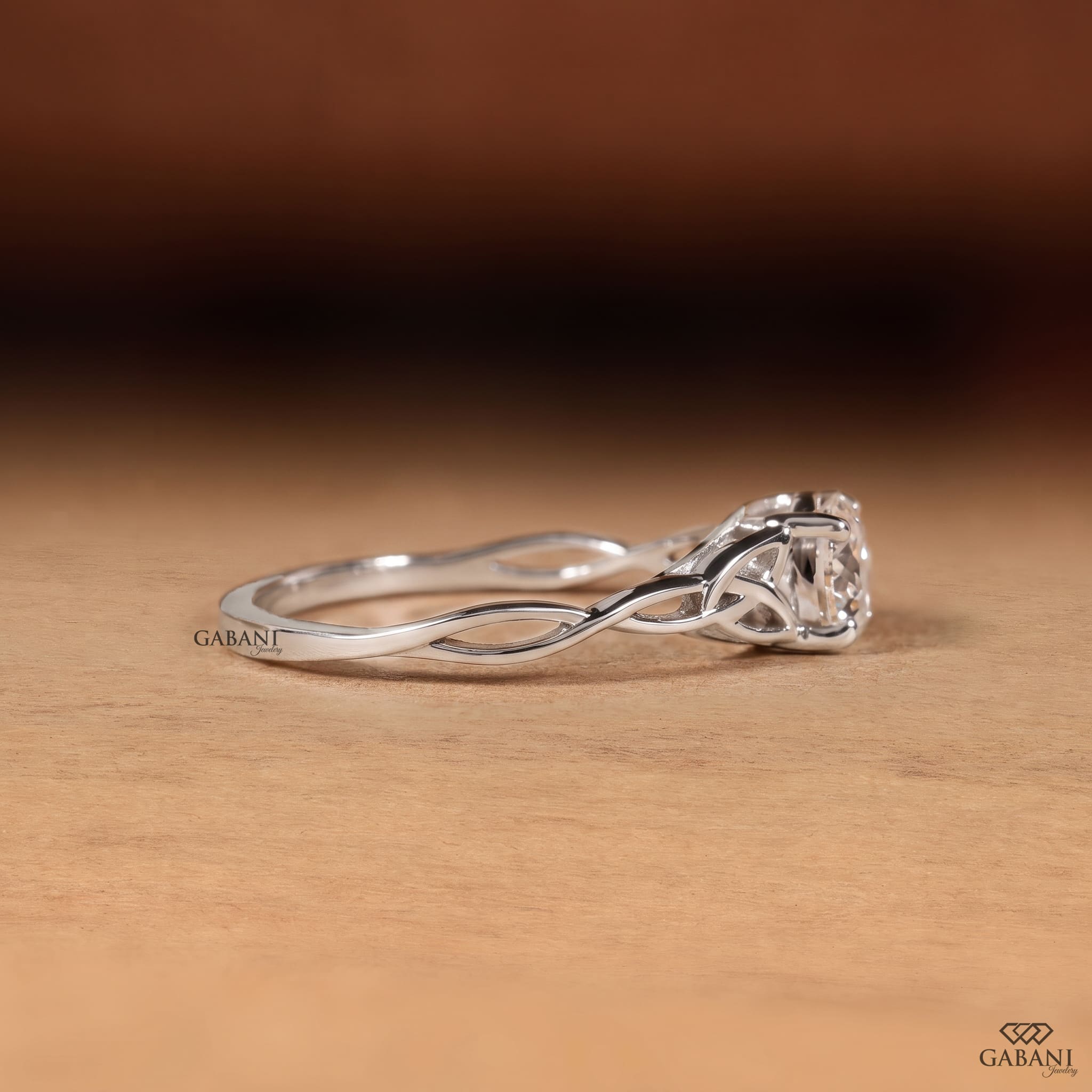 Portuguese cut lab grown diamond engagement ring with four-prong setting and nature-inspired open leaf vine white gold band.