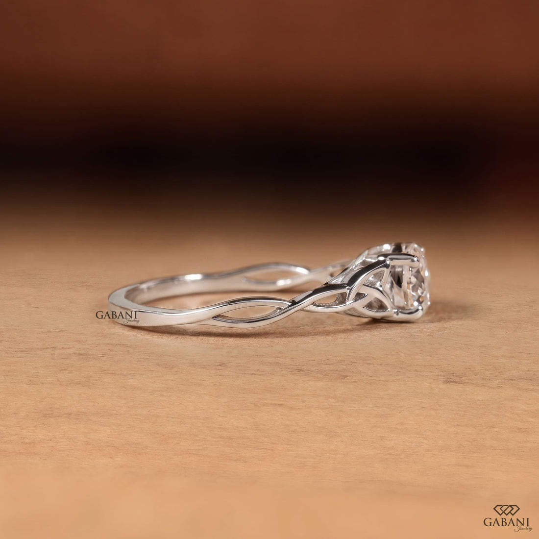 Portuguese cut lab grown diamond engagement ring with four-prong setting and nature-inspired open leaf vine white gold band.