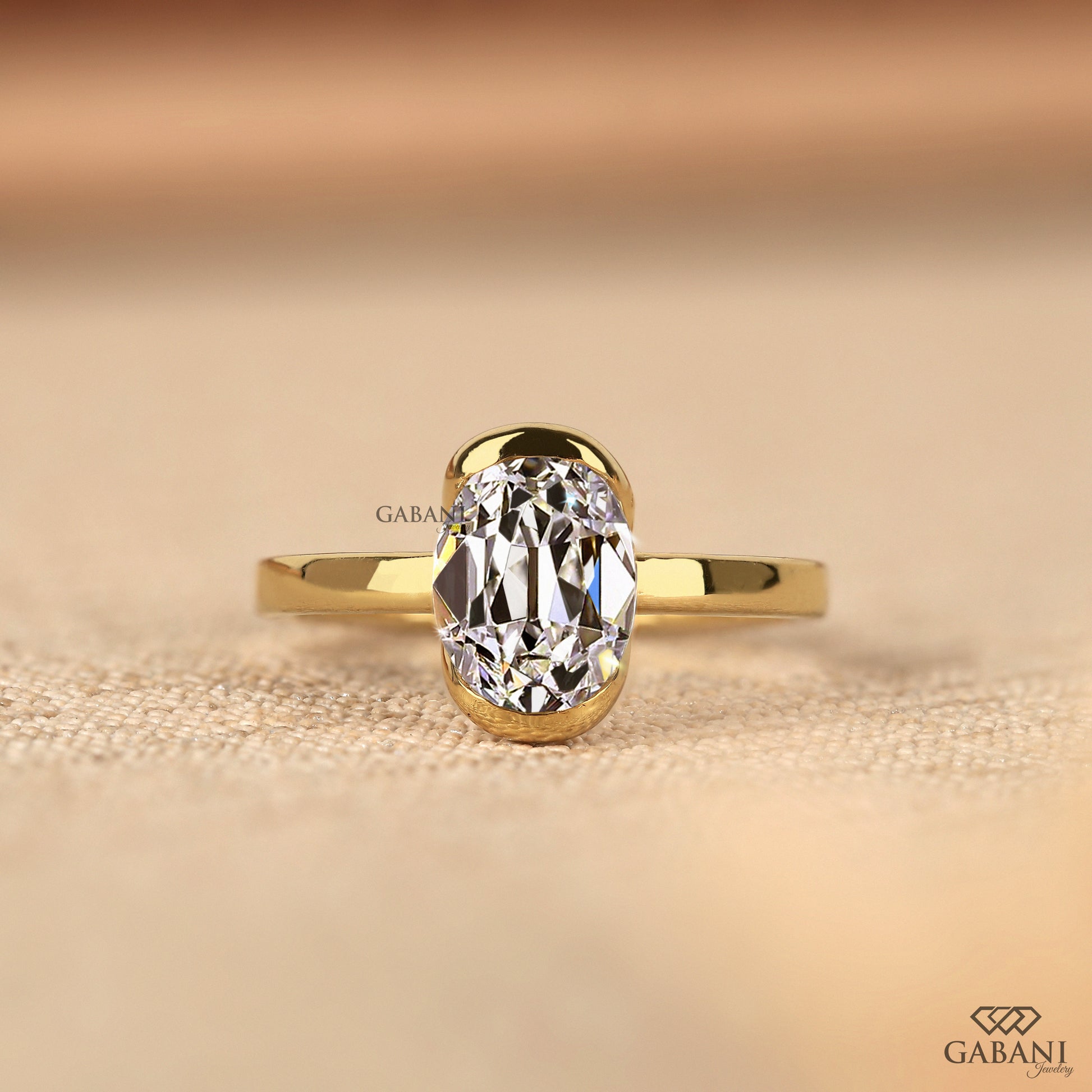 Old mine oval lab grown diamond solitaire ring in yellow gold with half bezel setting, comfort fit design
