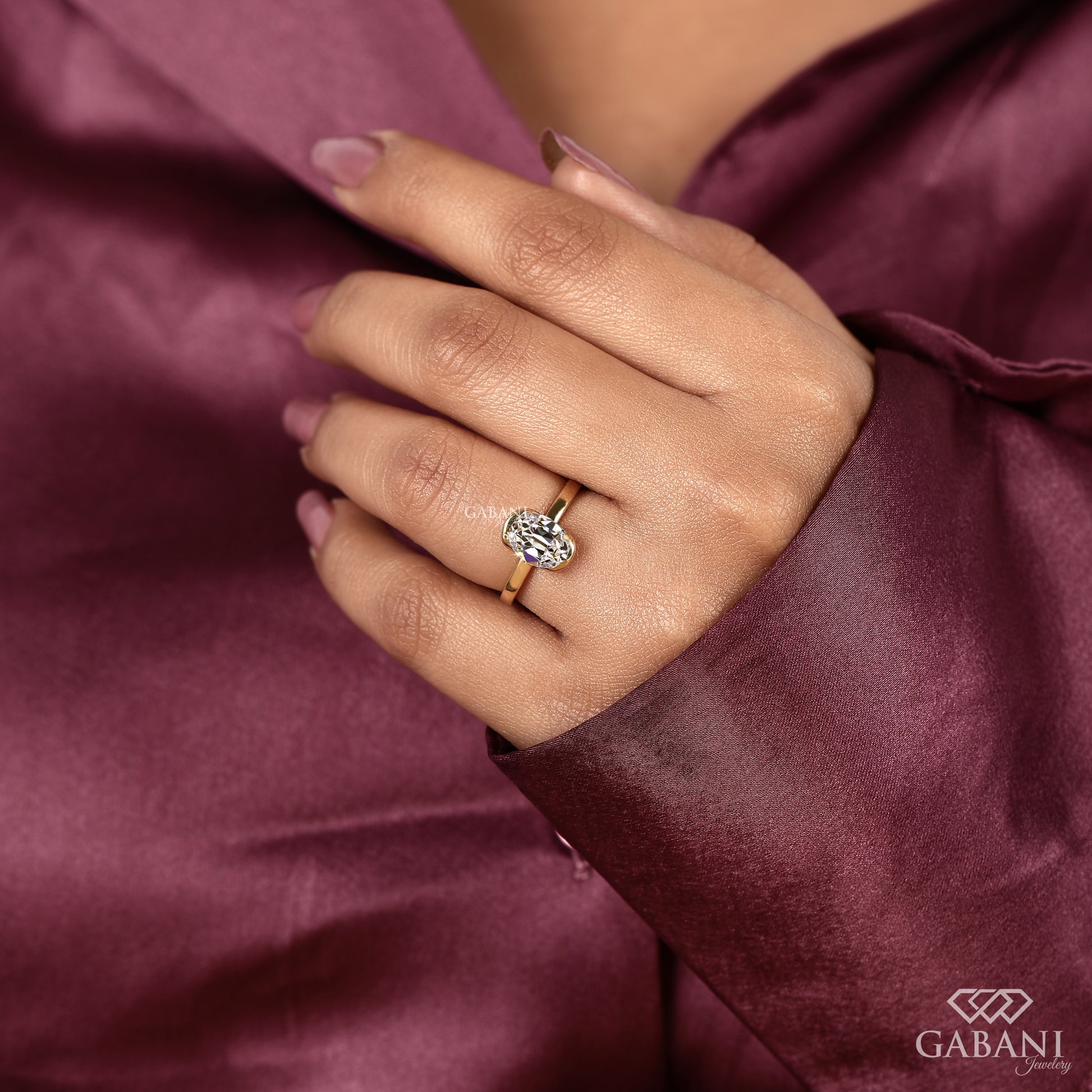 Handpicked lab grown diamond solitaire ring with old mine oval cut and half bezel style