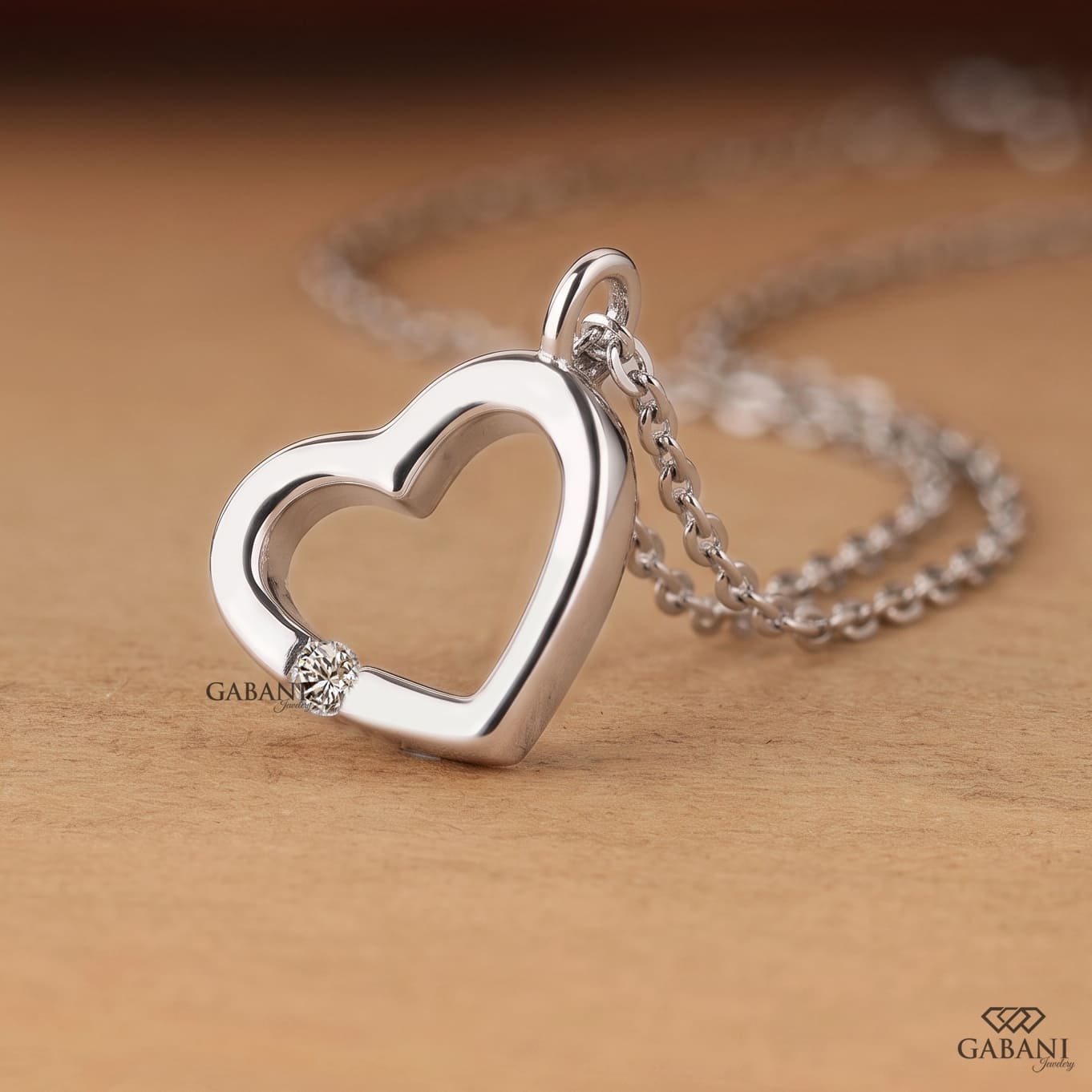 Open heart lab grown diamond pendant necklace in polished white gold featuring a single round cut diamond accent and delicate link chain.