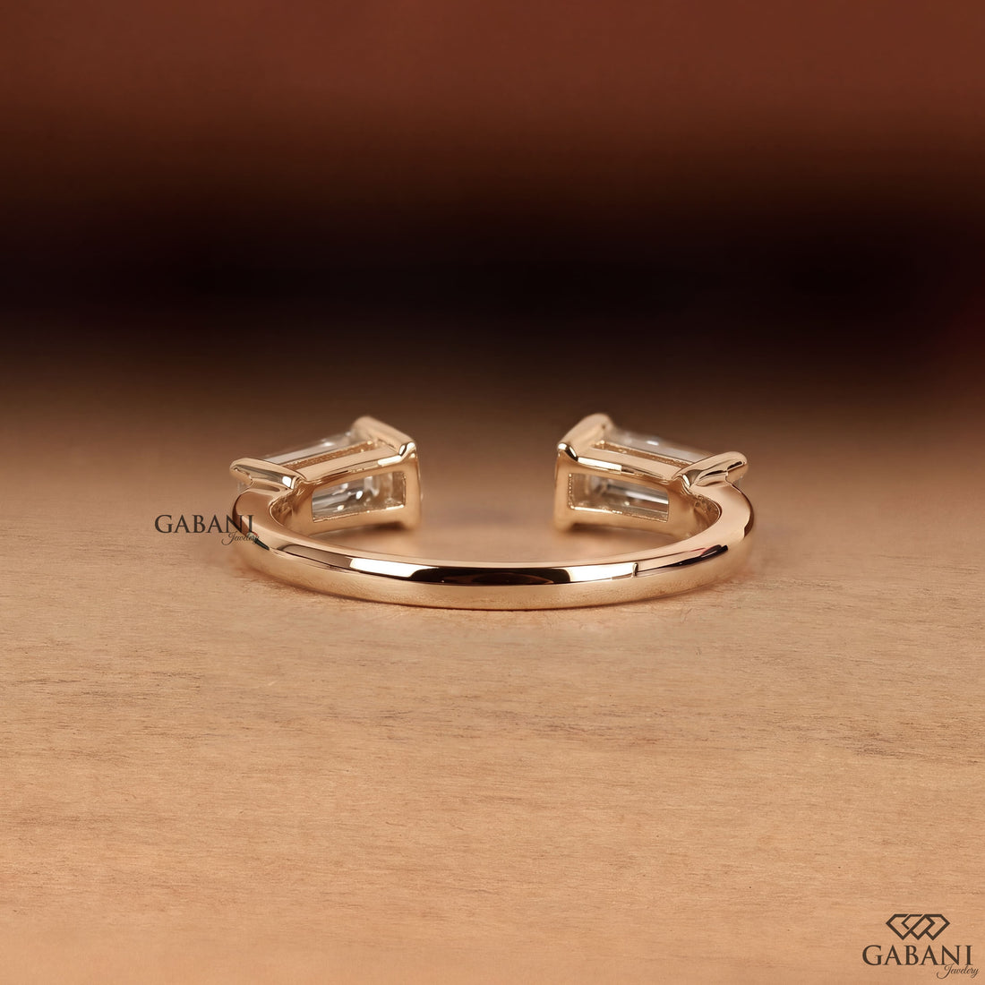 a tapered baguette cut lab grown diamond open cuff ring in 14K yellow gold, featuring two horizontally set diamonds in a modern minimalist design by Gabani Jewelry.