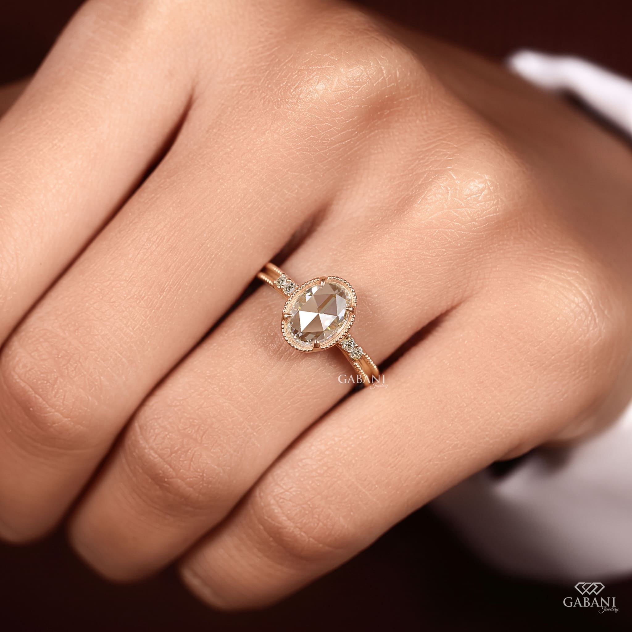 Oval rose cut lab grown diamond engagement ring with round side diamonds, vintage milgrain detailing and split shank design.