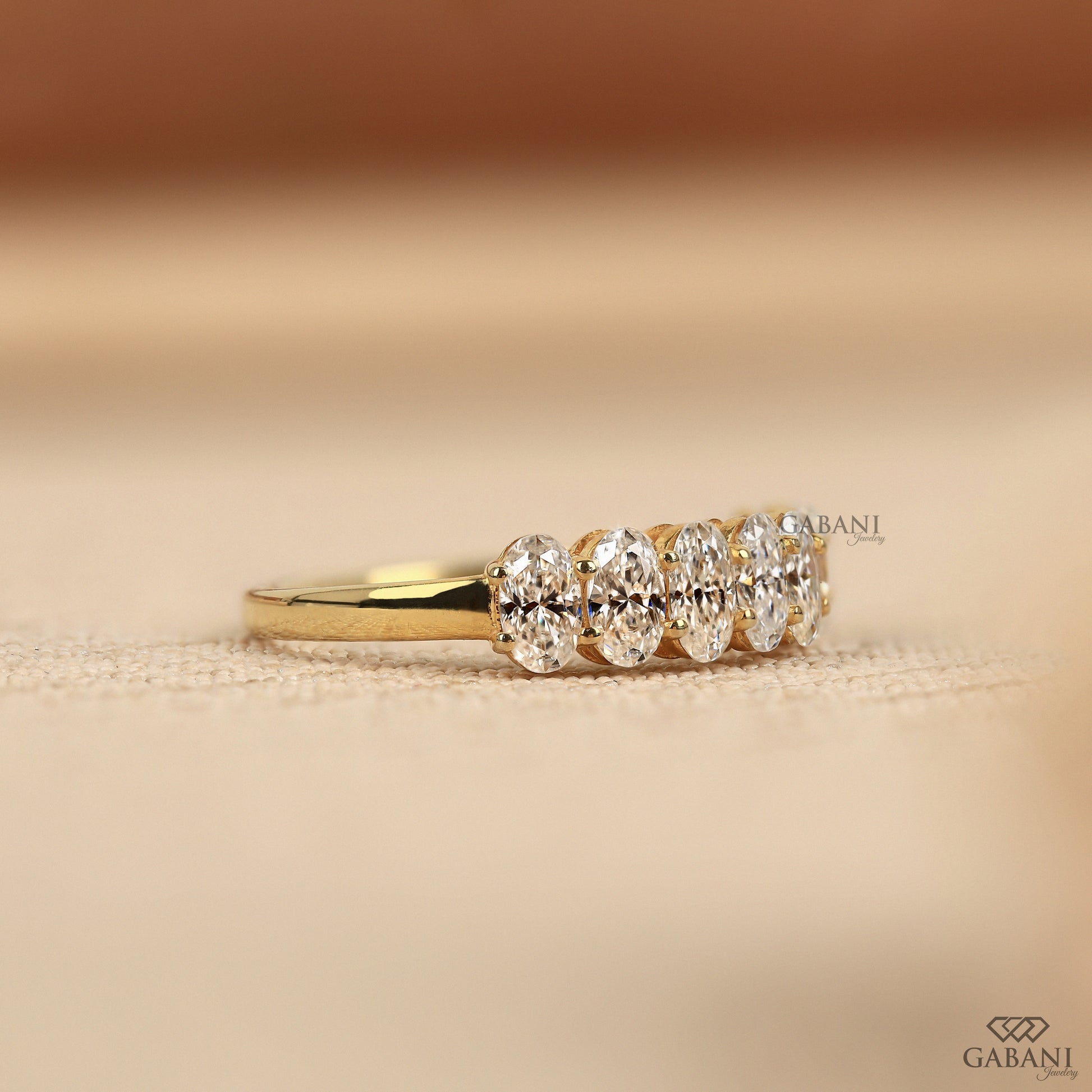 seven stone lab created diamond band with oval diamonds set in yellow gold