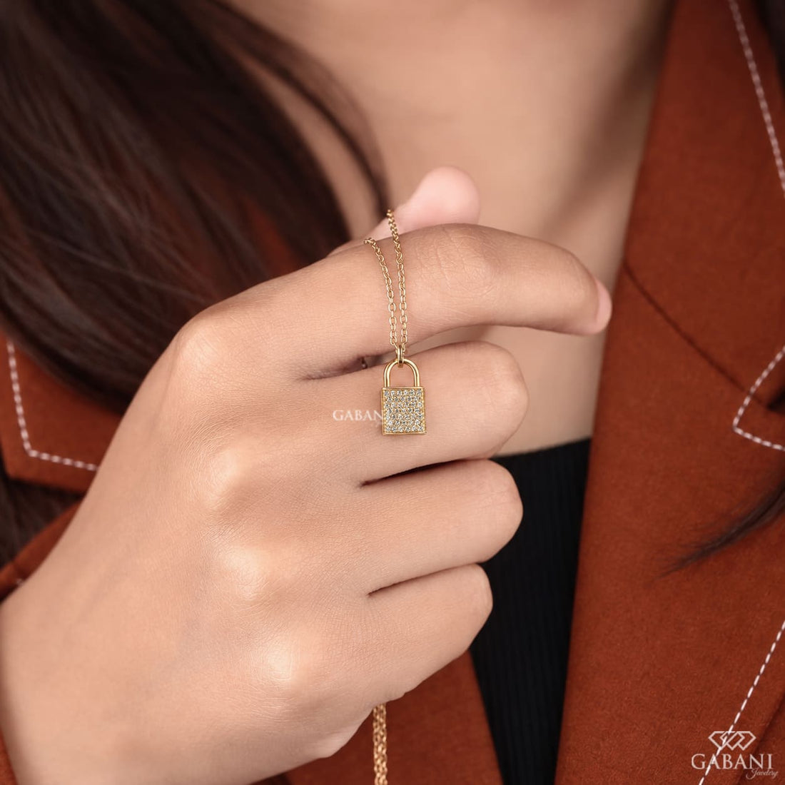 Yellow gold padlock pendant necklace featuring rows of round cut lab grown diamonds in a pavé setting with a polished gold shackle.