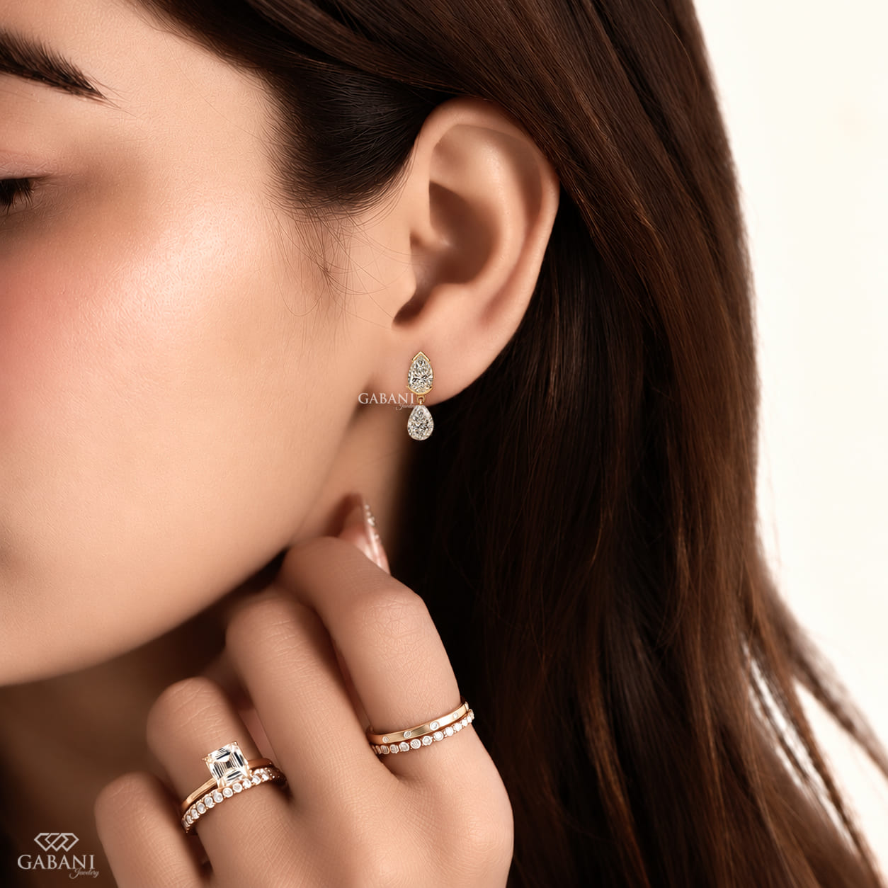 pear cut lab grown diamond drop earrings in yellow gold, featuring two sparkling pear-shaped diamonds on each earring in an elegant double teardrop design by Gabani Jewelry.