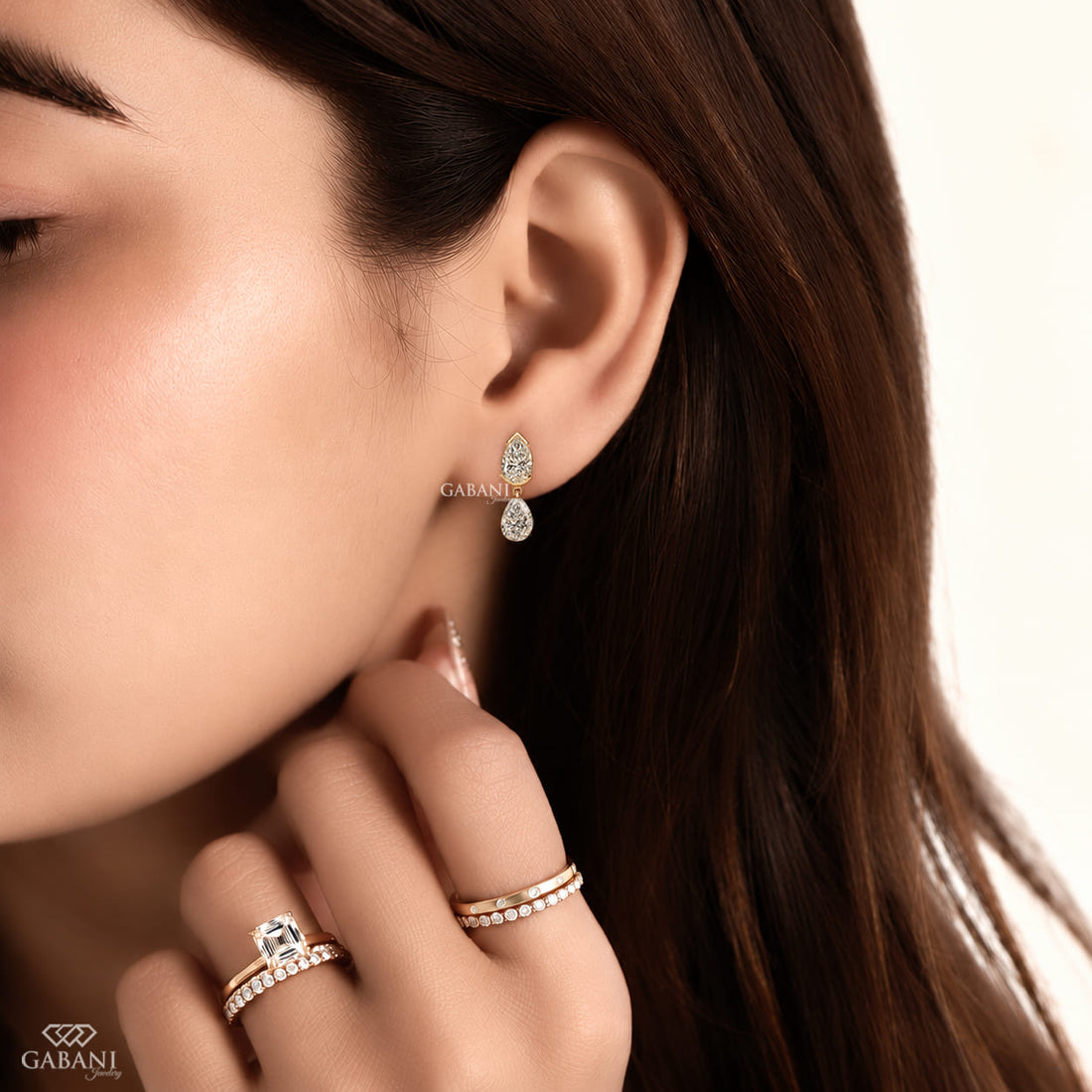 pear cut lab grown diamond drop earrings in yellow gold, featuring two sparkling pear-shaped diamonds on each earring in an elegant double teardrop design by Gabani Jewelry.