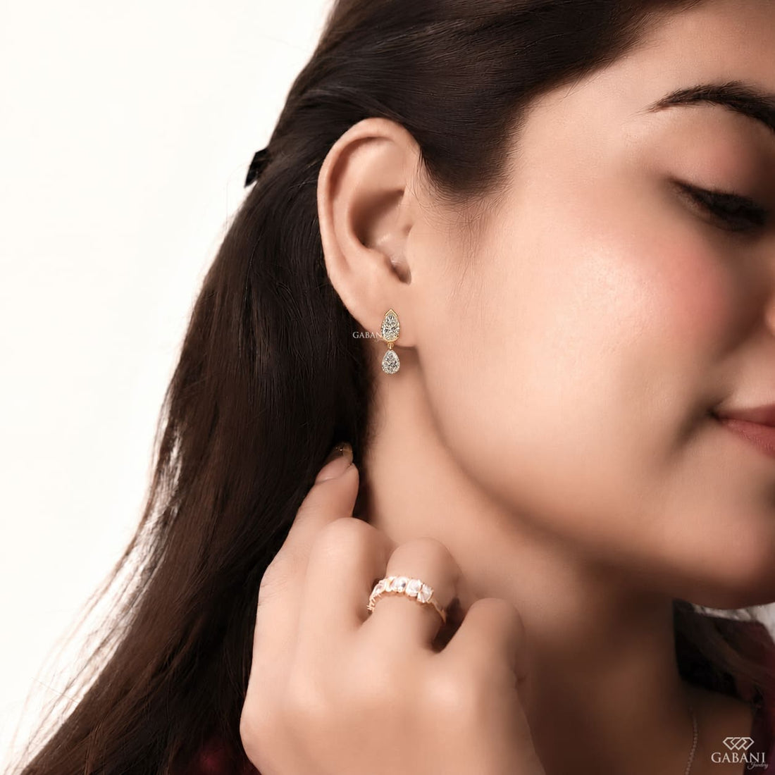 pear cut lab grown diamond drop earrings in yellow gold, featuring two sparkling pear-shaped diamonds on each earring in an elegant double teardrop design by Gabani Jewelry.