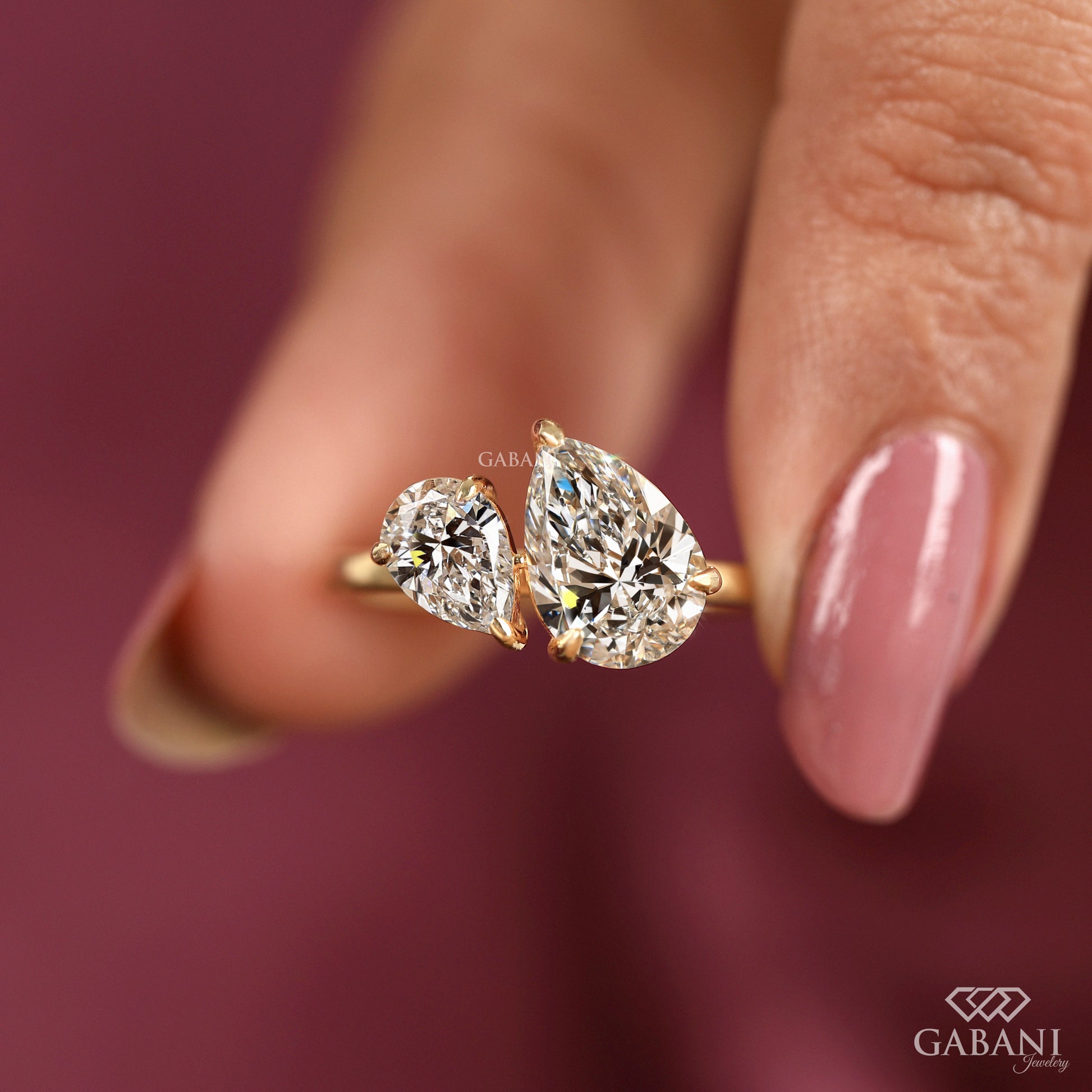 toi et moi ring showcasing twin teardrop lab grown diamonds in yellow gold pipe shank band