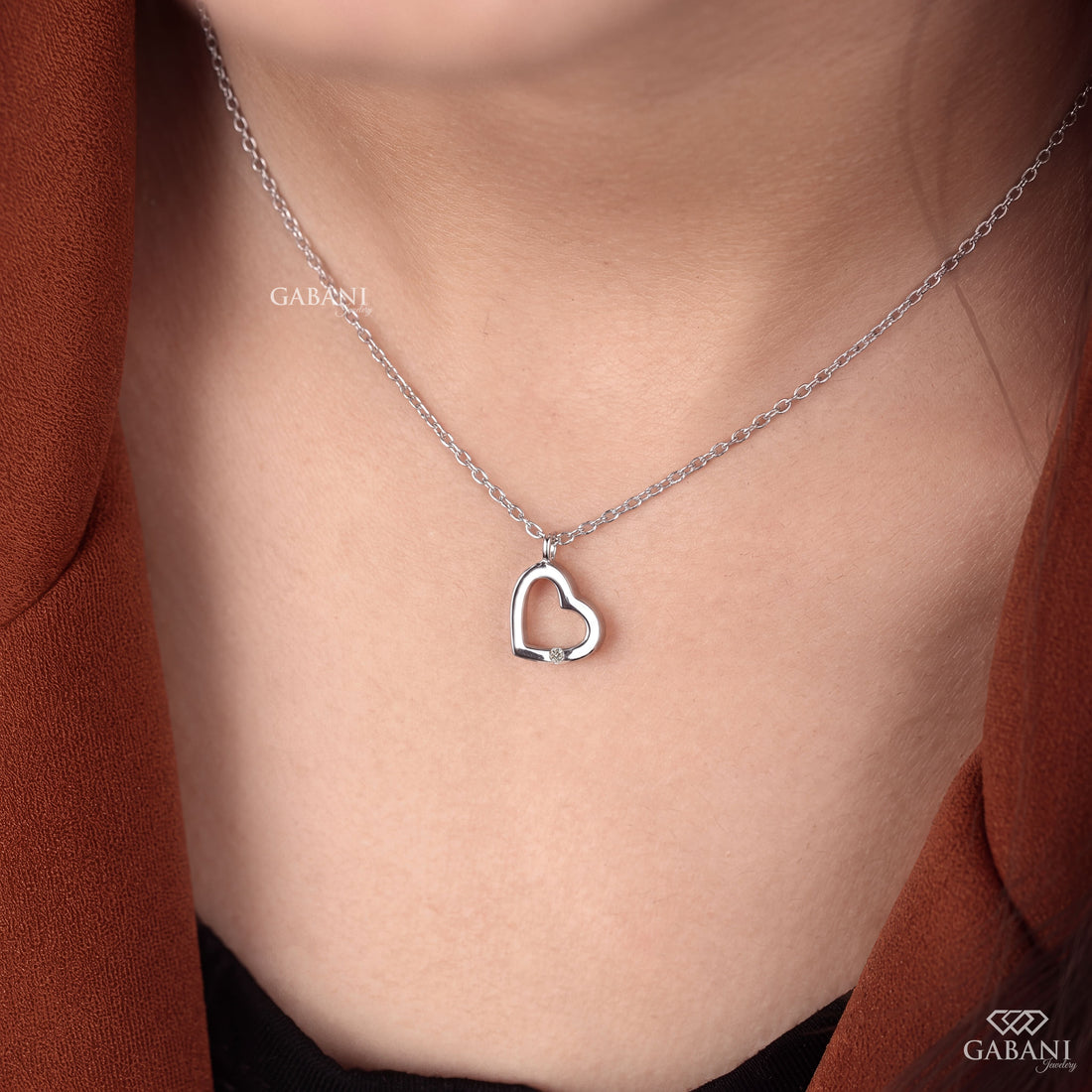 Open heart lab grown diamond pendant necklace in polished white gold featuring a single round cut diamond accent and delicate link chain.