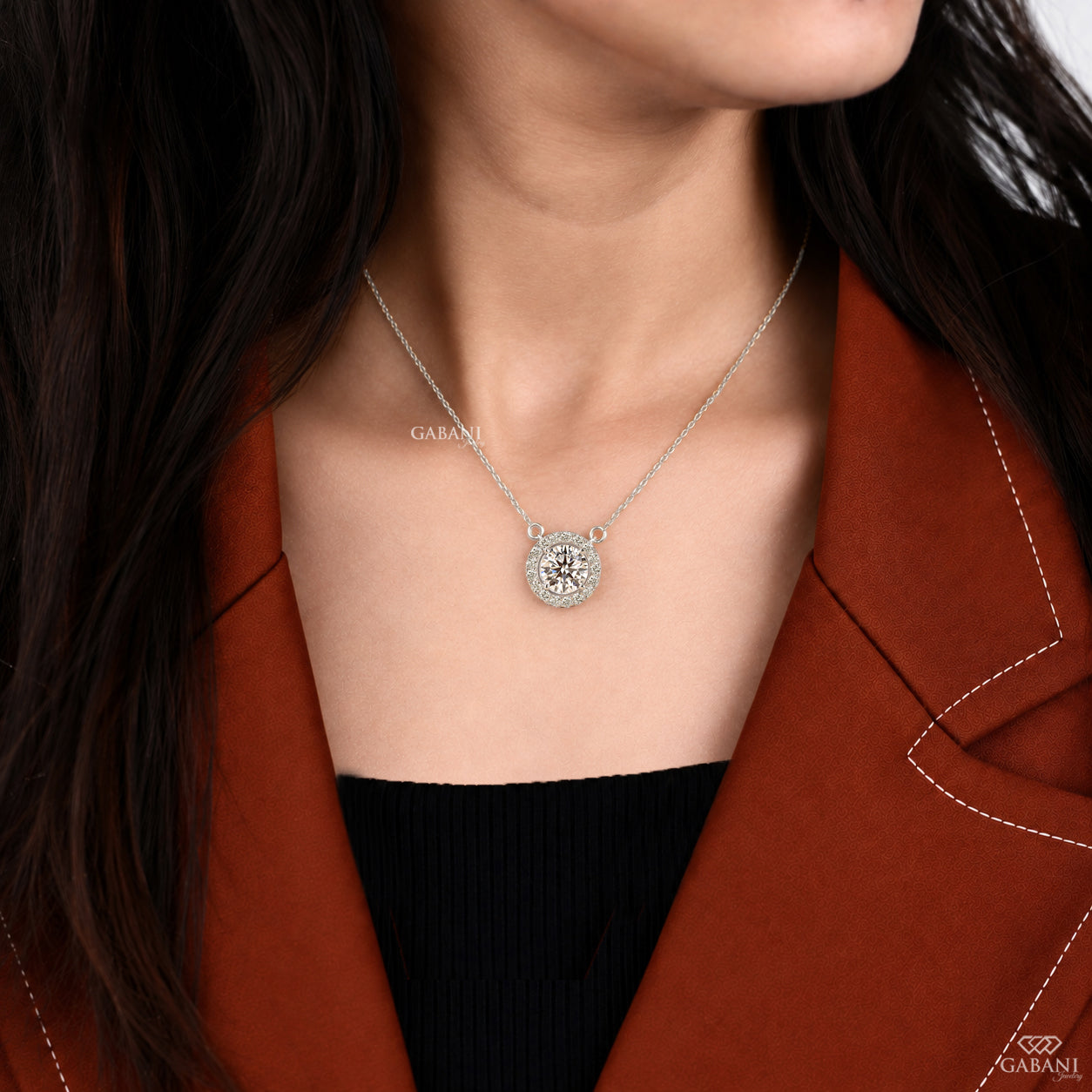 Round cut lab grown diamond floating halo pendant in white gold with a four prong center setting and circular pavé diamond halo.
