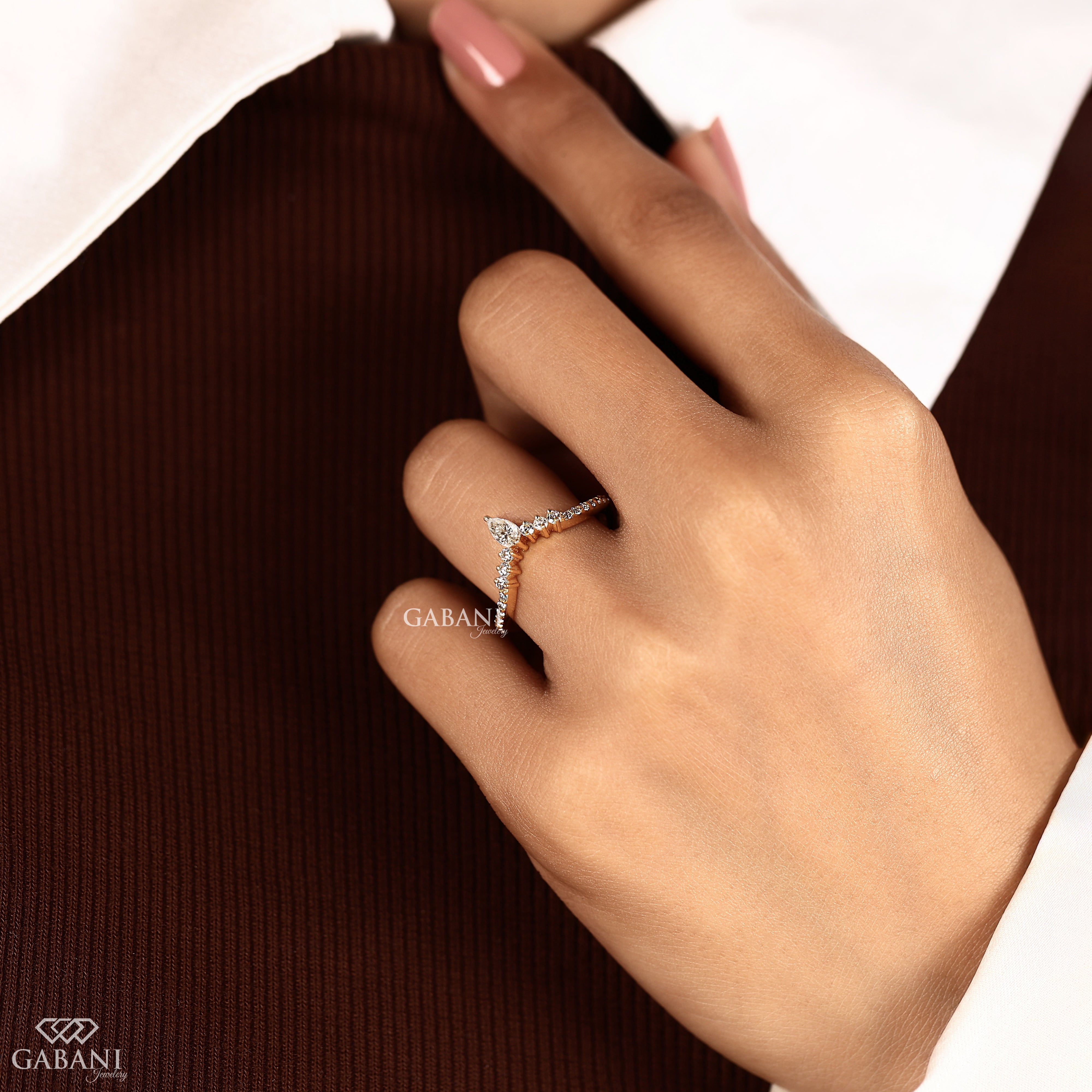 Long view of pear cut lab grown diamond curved wedding band in solid gold