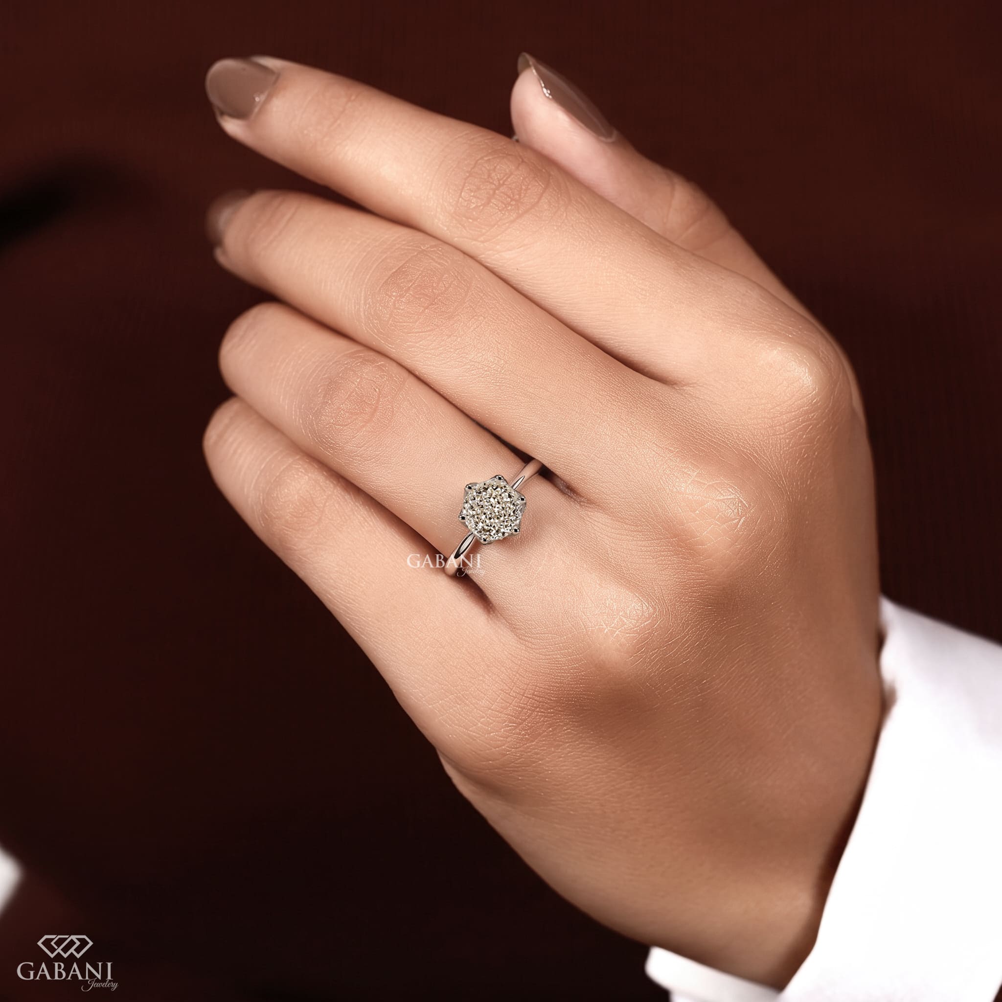 Round Portuguese cut lab grown diamond solitaire engagement ring in white gold with a six-prong floral basket and polished band.