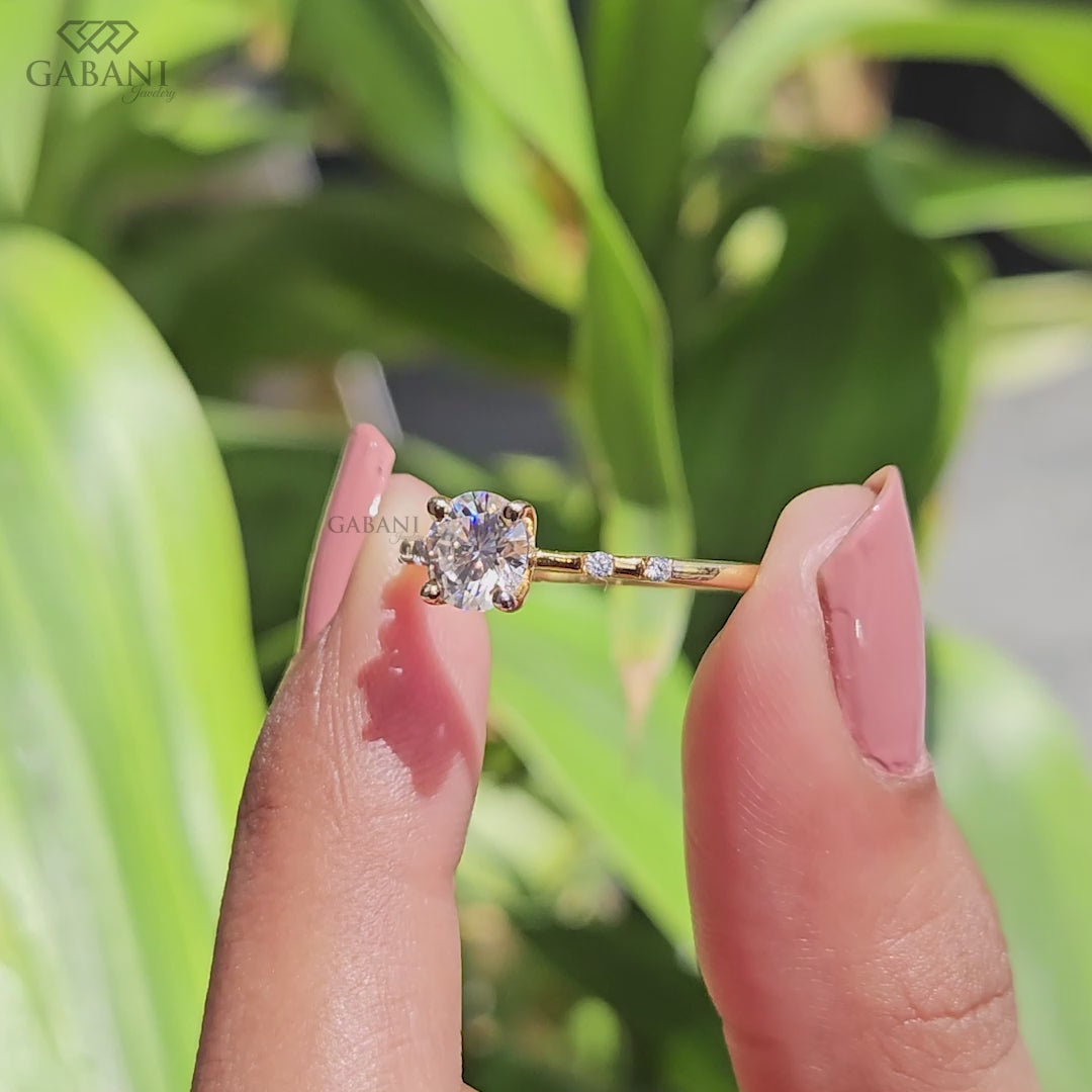 Handcrafted round lab grown diamond engagement ring in 14K yellow gold with a born style shank and fancy flush setting by Gabani Jewelry.