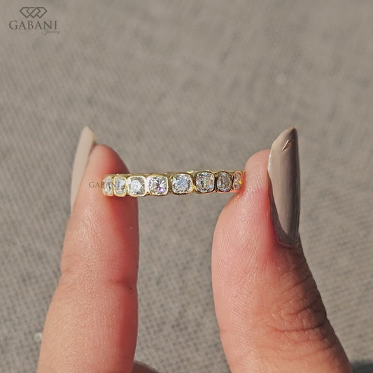 Cushion cut lab created diamond eternity band featuring bezel setting and full continuous diamond design