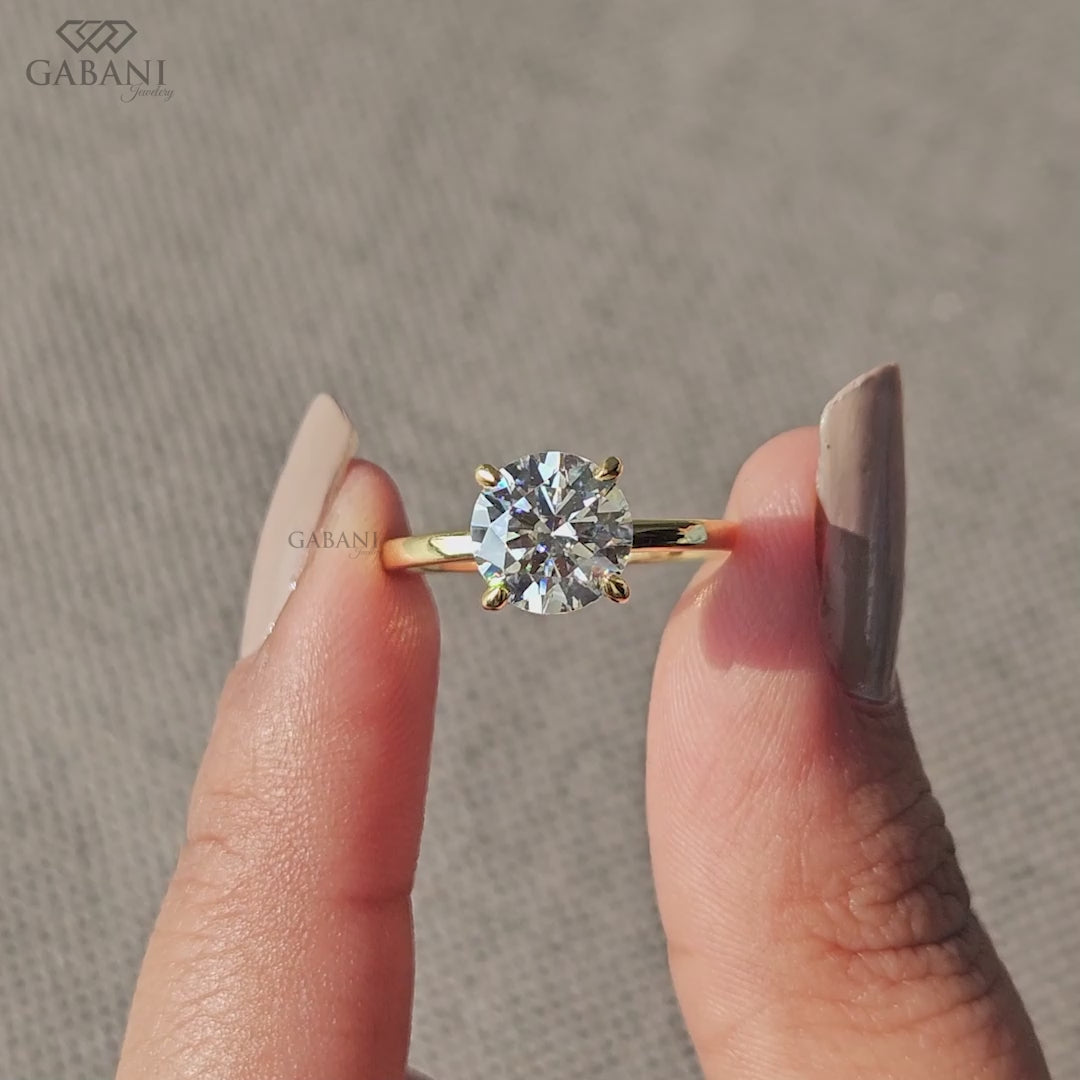 round cut lab grown diamond ring with prong setting and smooth yellow gold band
