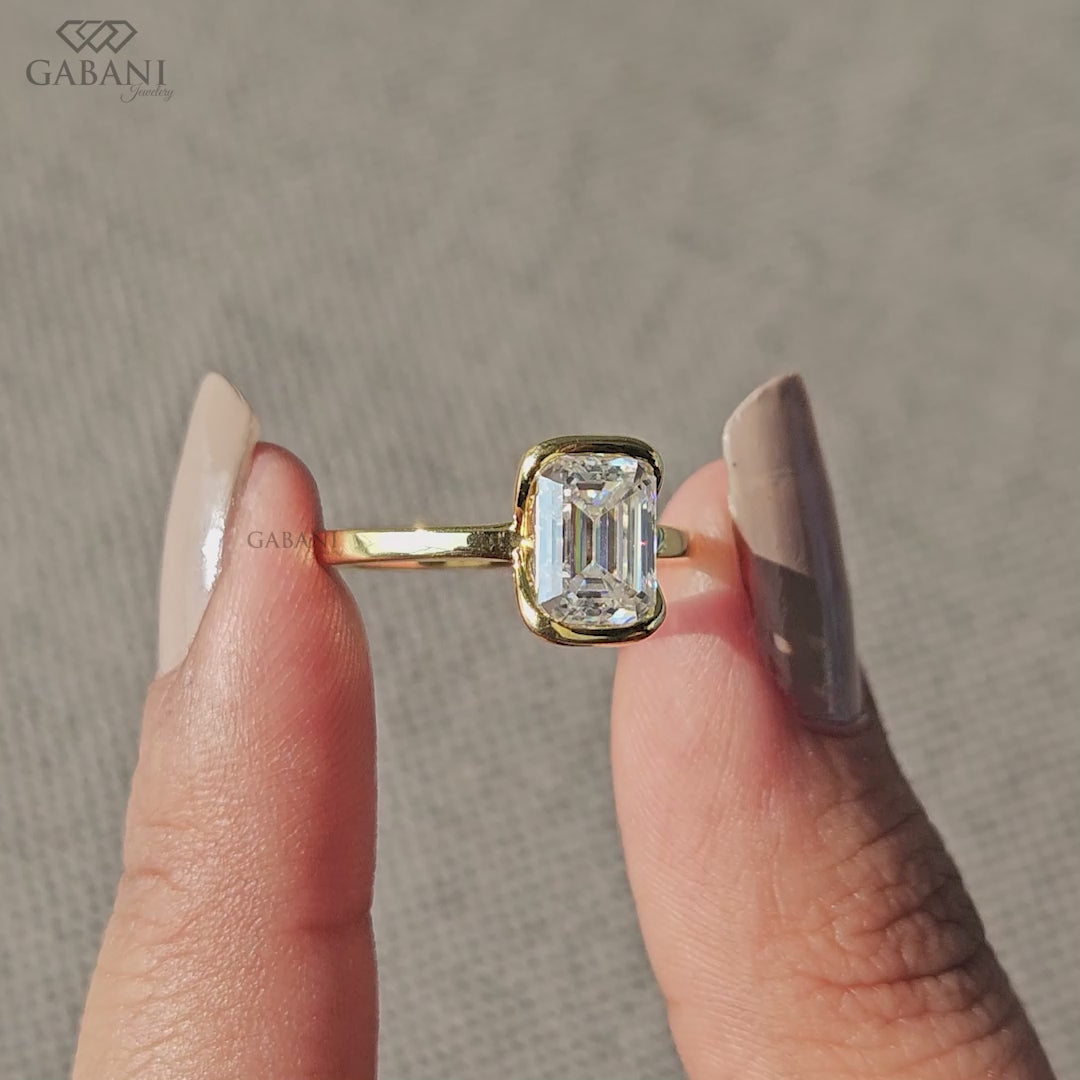 half bezel emerald cut lab grown diamond ring crafted in smooth yellow gold
